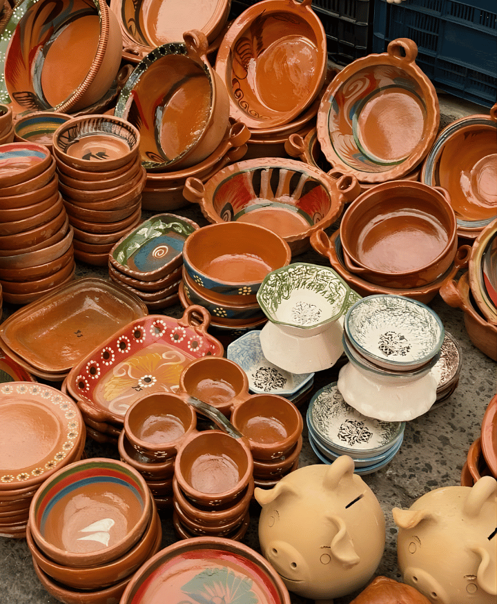 Collection of handmade pottery and ceramic dishes including bowls and decorative clay items