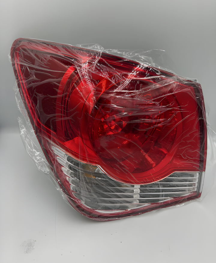 Red car tail light assembly wrapped in plastic for protection