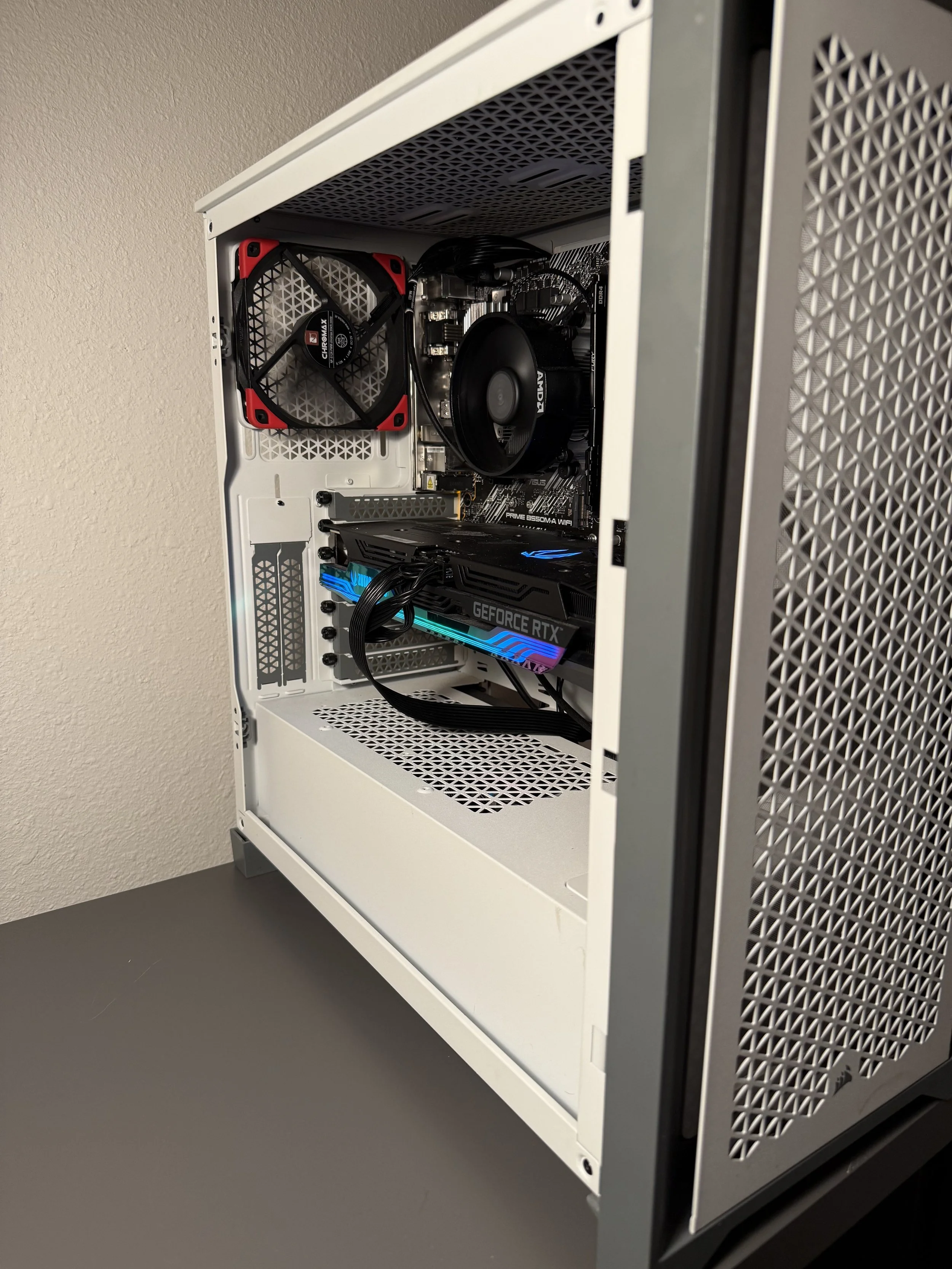 Interior view of a desktop computer tower with a graphics card, a CPU cooler, a case fan, and various internal components visible.