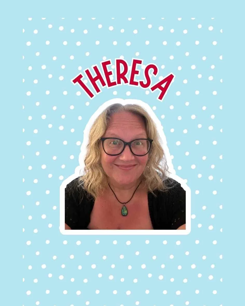 A woman with glasses smiling, wearing a necklace with a green pendant, against a light blue background with white polka dots, with red text above her head that reads "Theresa Organising Elf."