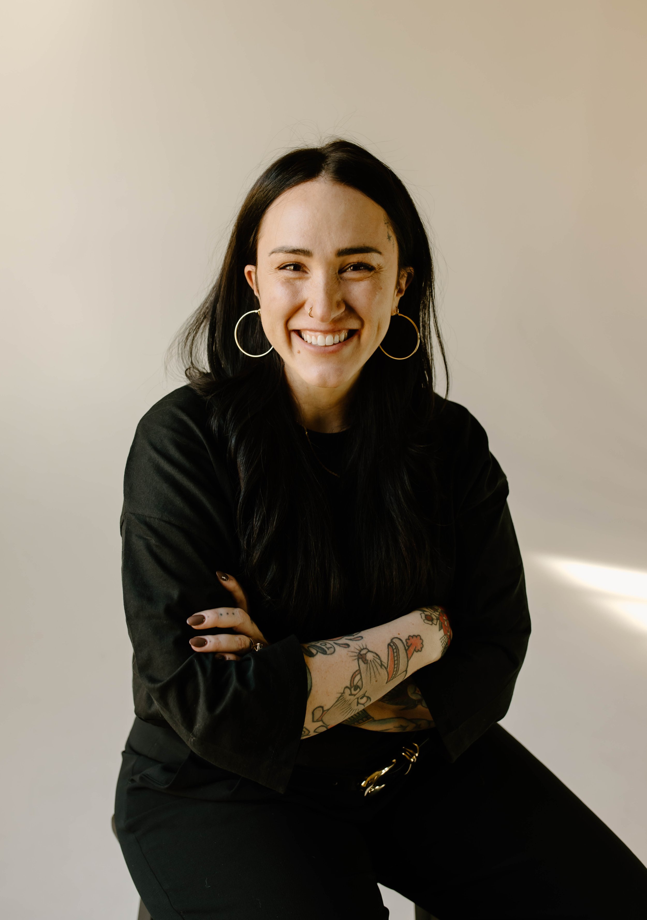 Cheyenne Kingsley, founder and growth marketer of Well & Wise Media Co., smiling with arms crossed. Based in Salt Lake City, Utah. Serving across U.S.