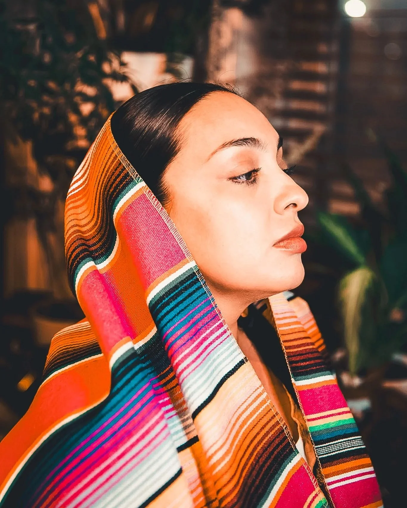 Angela Estrella Mejia of Angie Star Studios wearing a serape (ancestral garb)