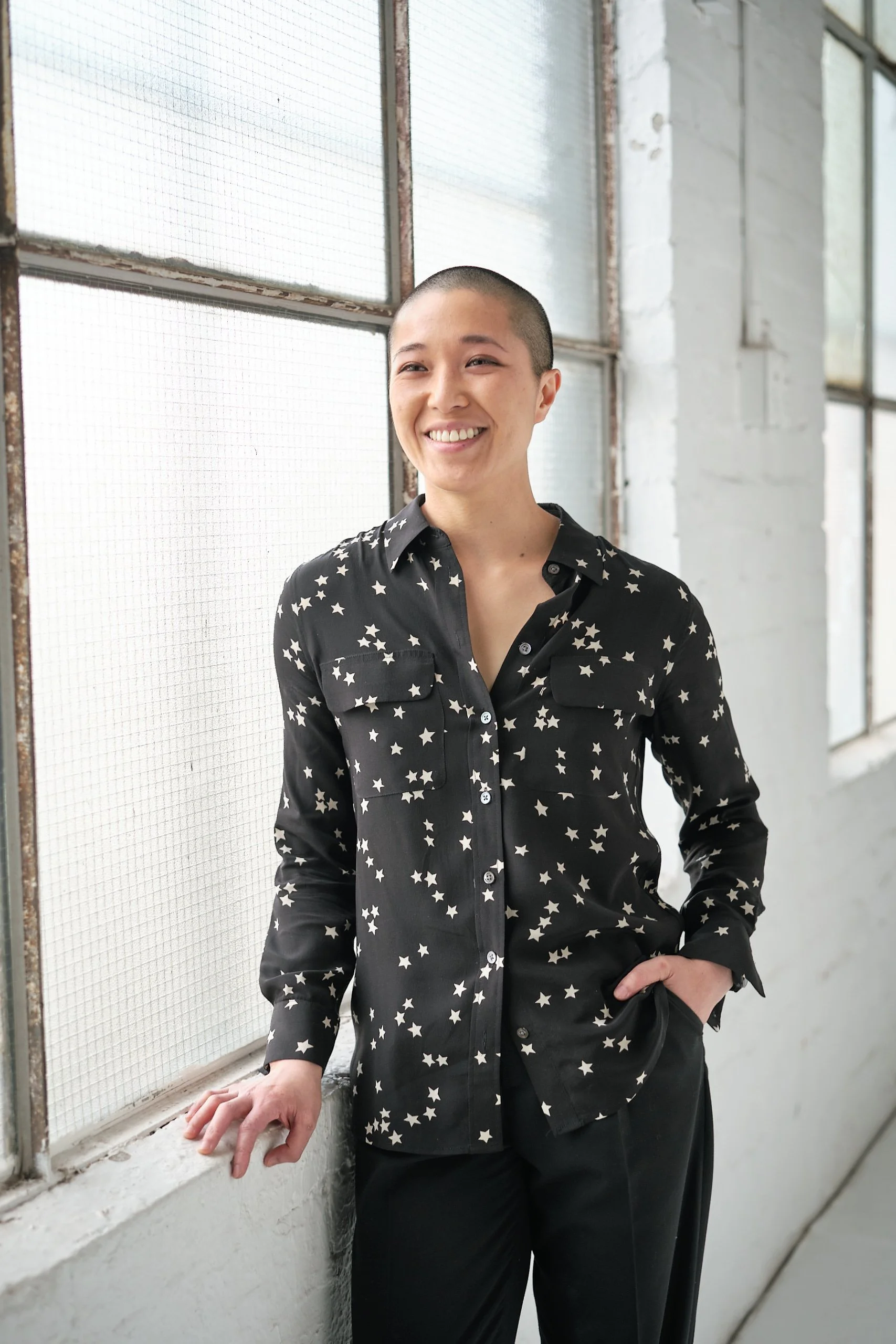 A smiling Jess Ho from the waist up.