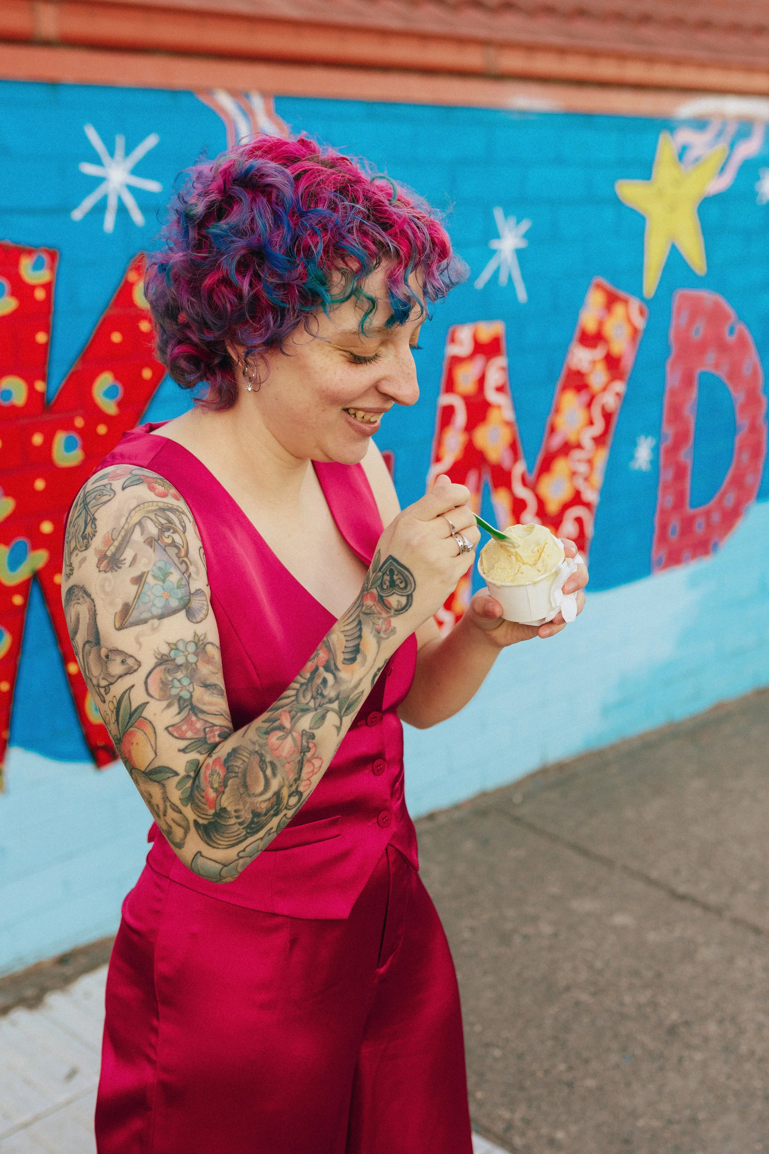 A smiling Logan Trask eating ice cream.