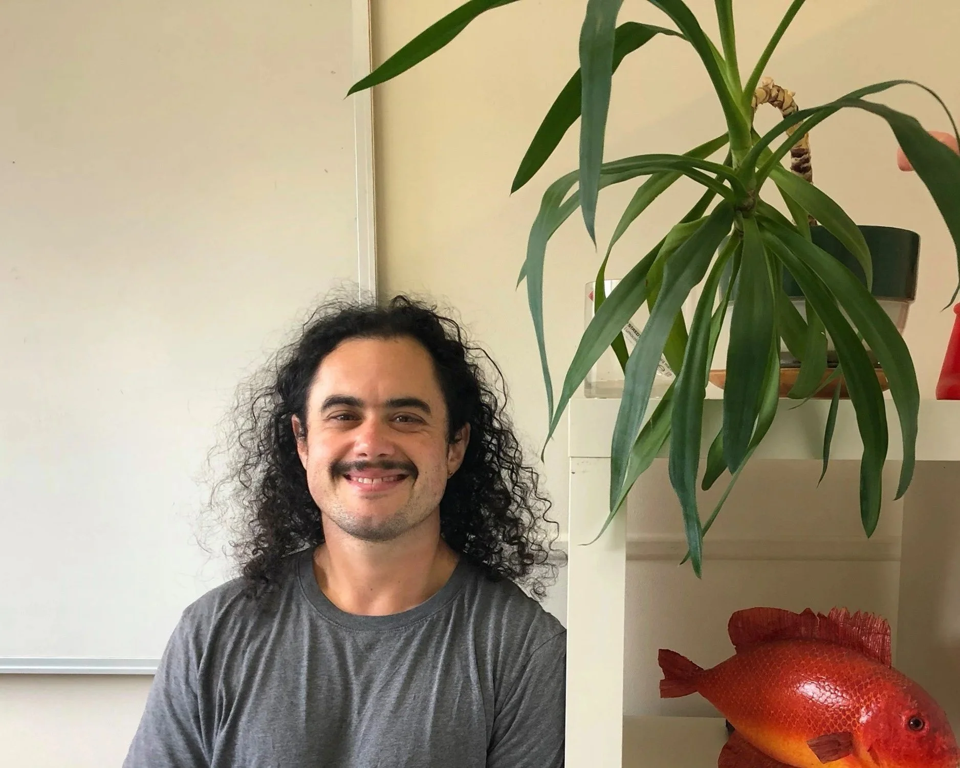 A smiling Arlie Alizzi from the shoulders up.