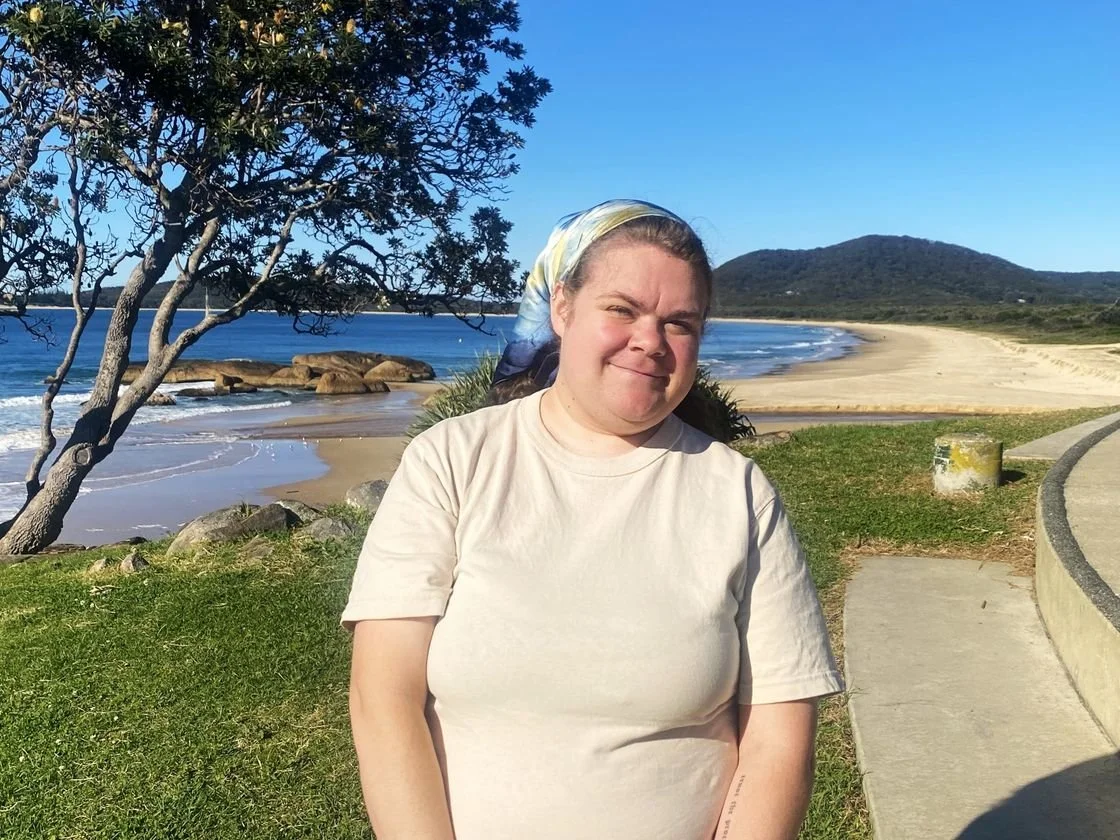 A smiling Lay Maloney from the waist up.