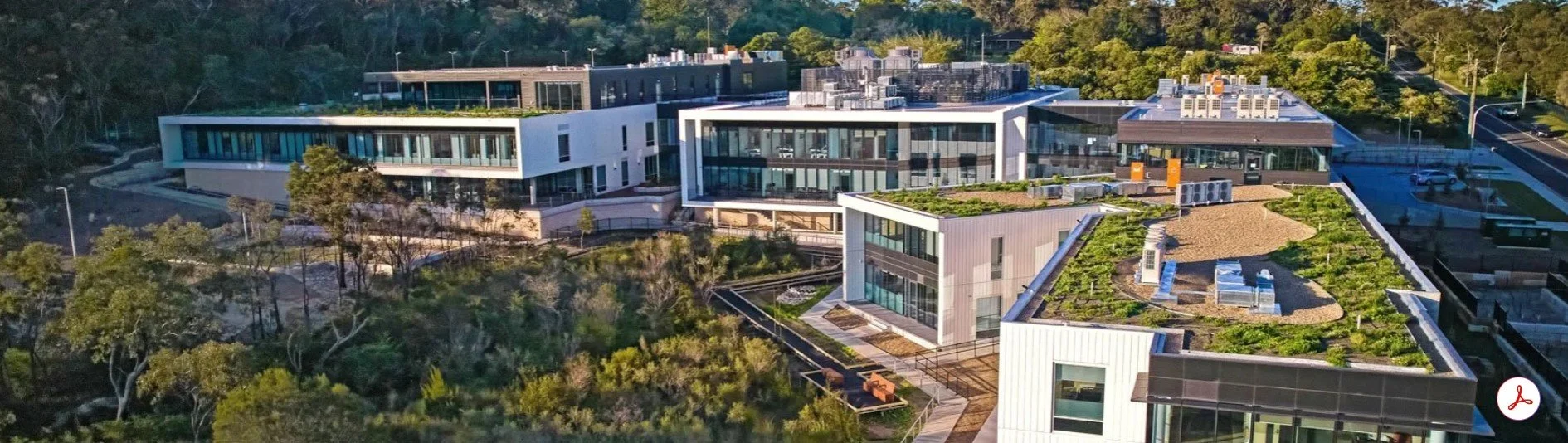 Wyvern Private Hospital Aerial view of modern office buildings with green roofs and surrounding trees.