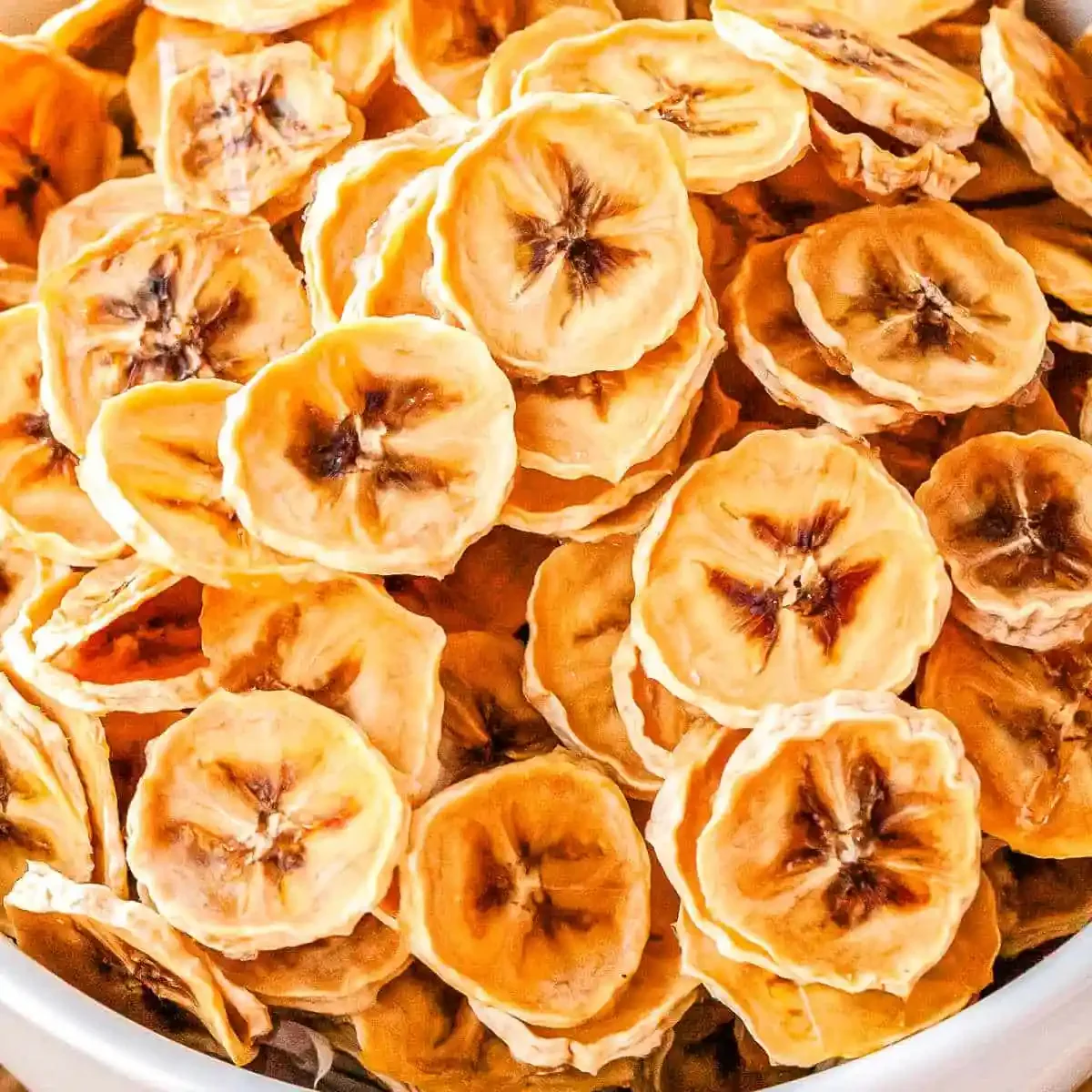 Close-up view of dried banana chips in a bowl.