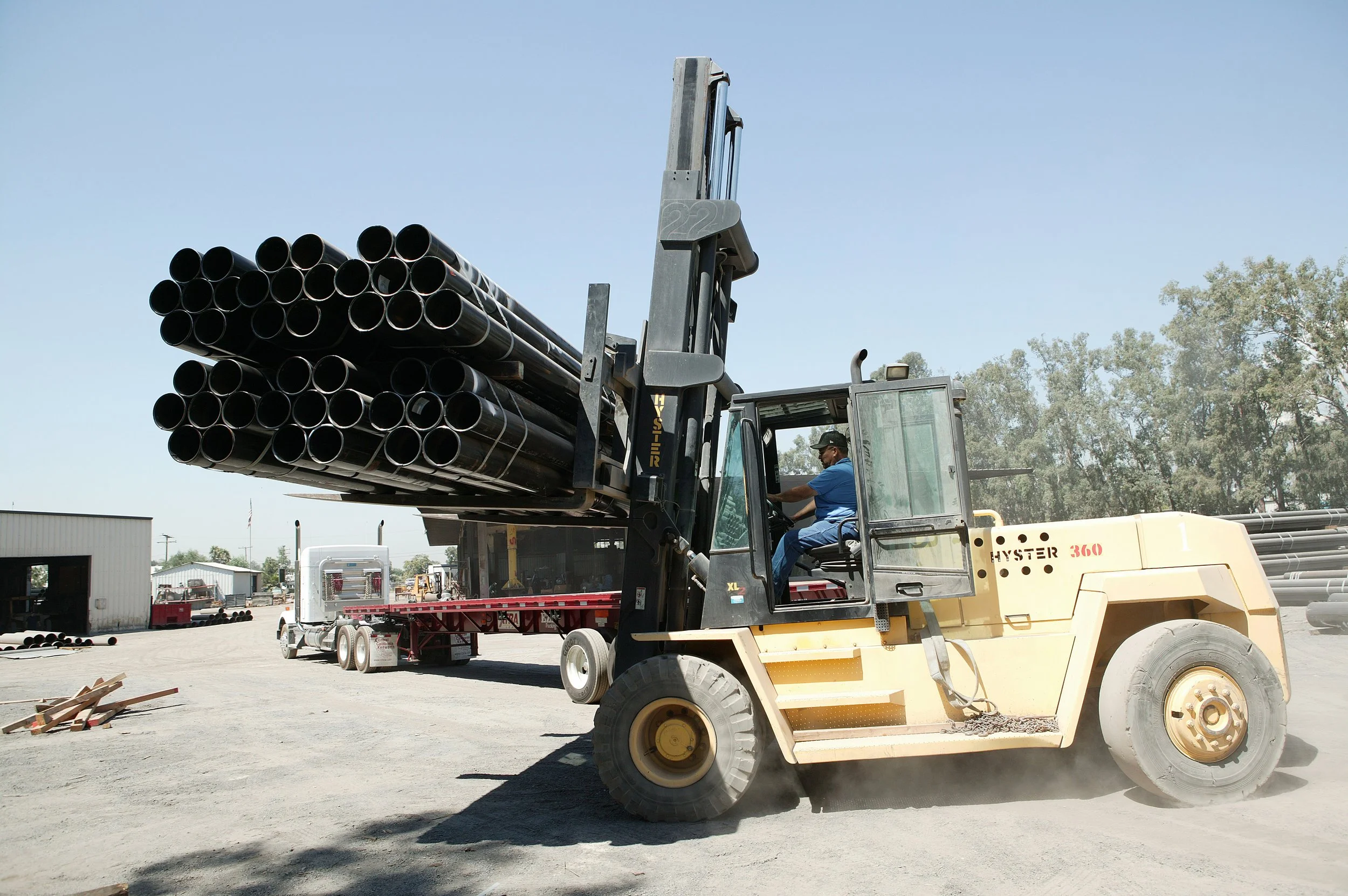 pipes being carried by a forklift