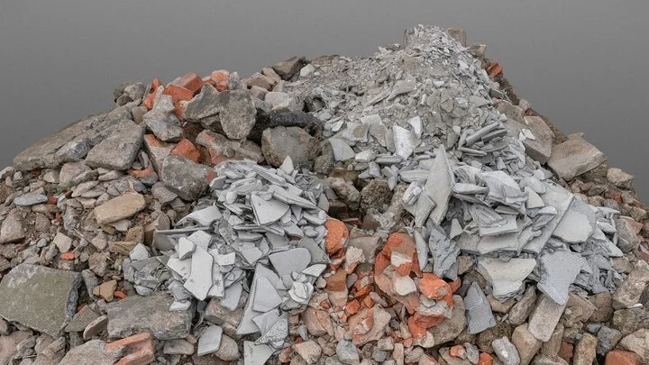 Pile of construction debris, including broken concrete, bricks, and rubble.