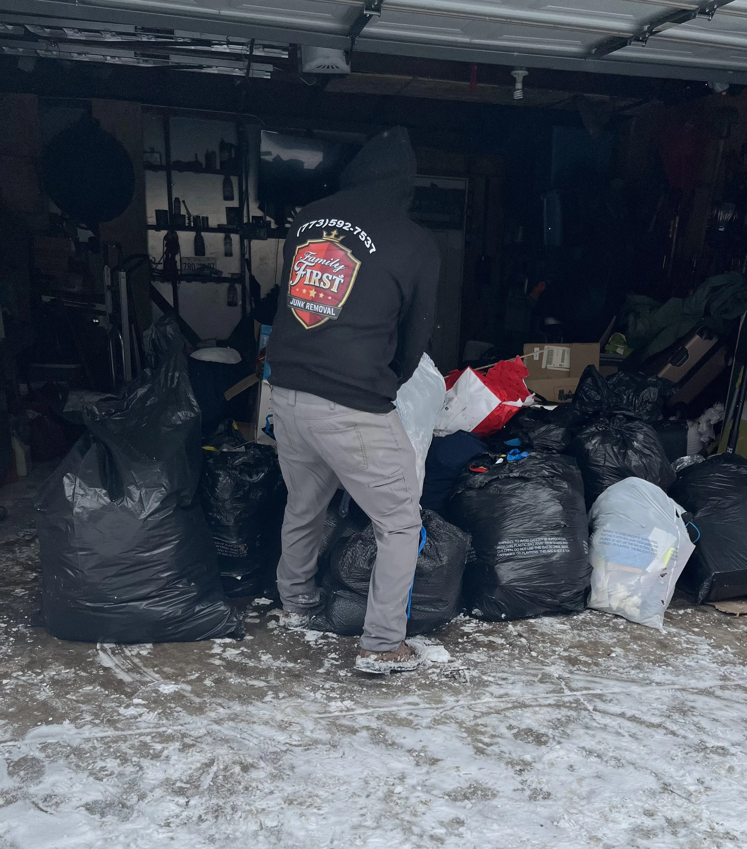 junk removal professional clearing out clutter from a residential garage