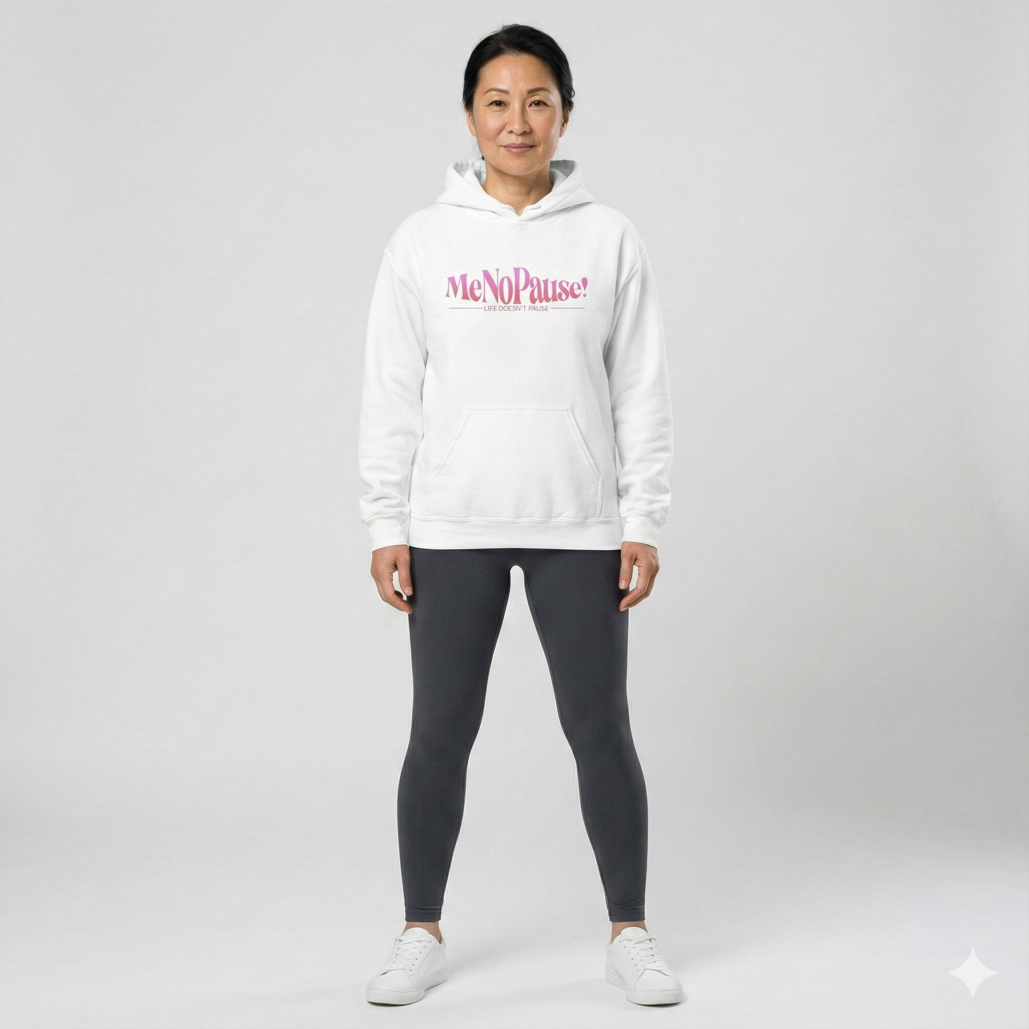 Woman wearing white unisex MeNoPause!™ Empowerment Hoodie with centered pink logo.