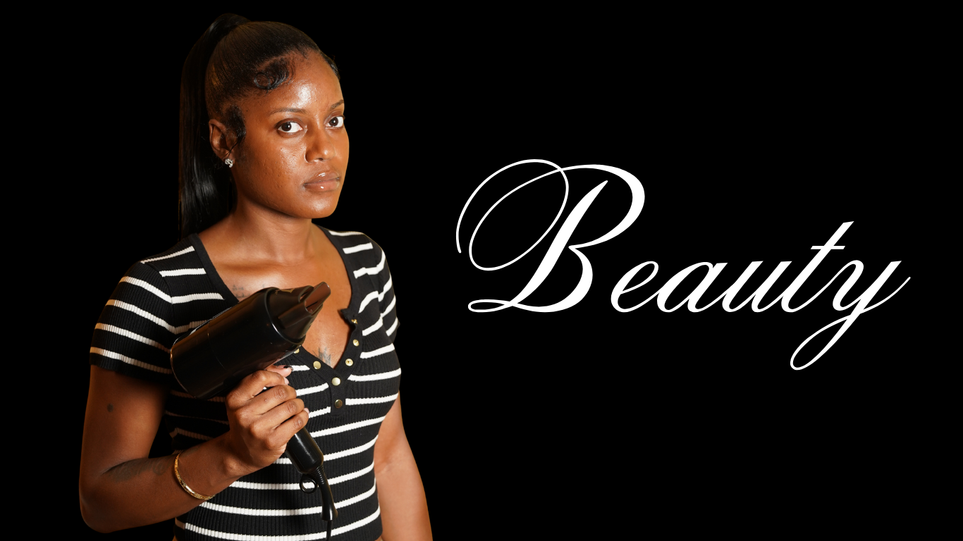A woman with dark hair in a high ponytail holding a black hairdryer, standing against a black background with the word 'Beauty' written in white cursive text.