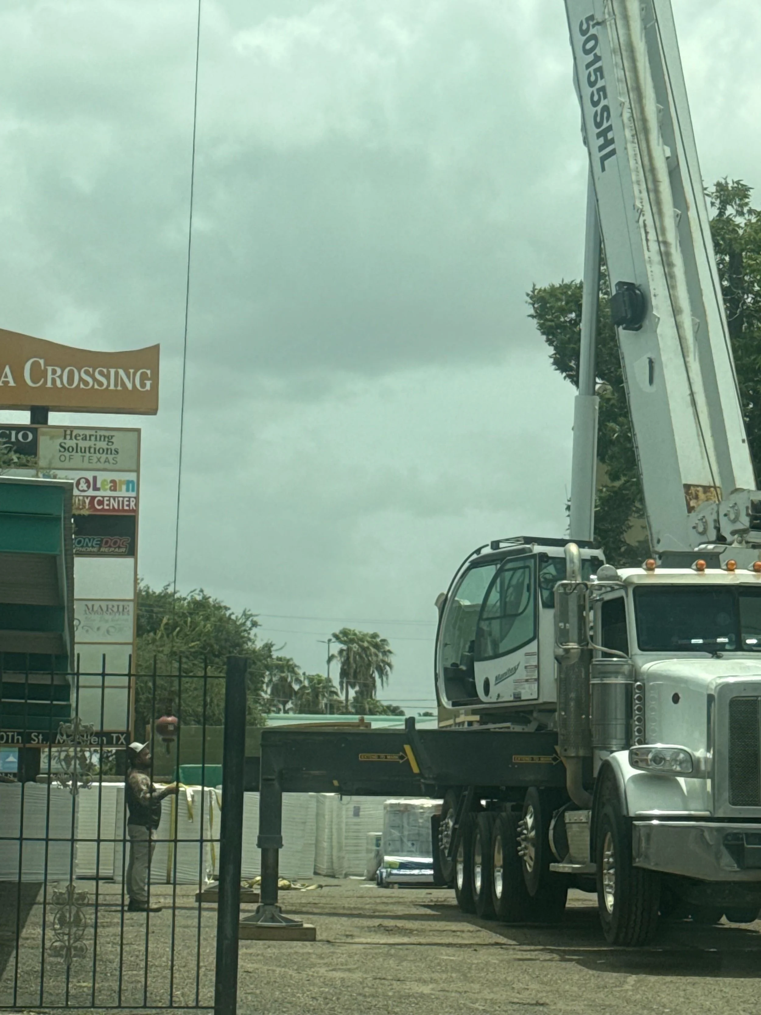 Commercial crane installation at multifamily property remodel site.jpg