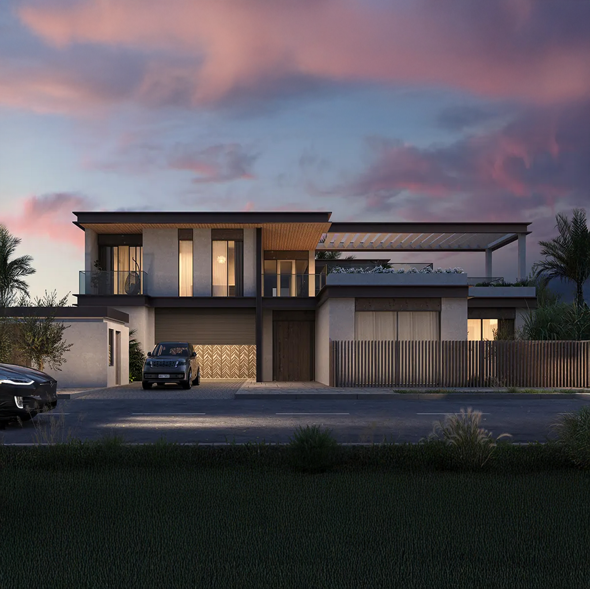 Modern two-story house with large windows, a balcony, and a rooftop terrace, surrounded by palm trees and parked cars, at sunset with a pink and purple sky.
