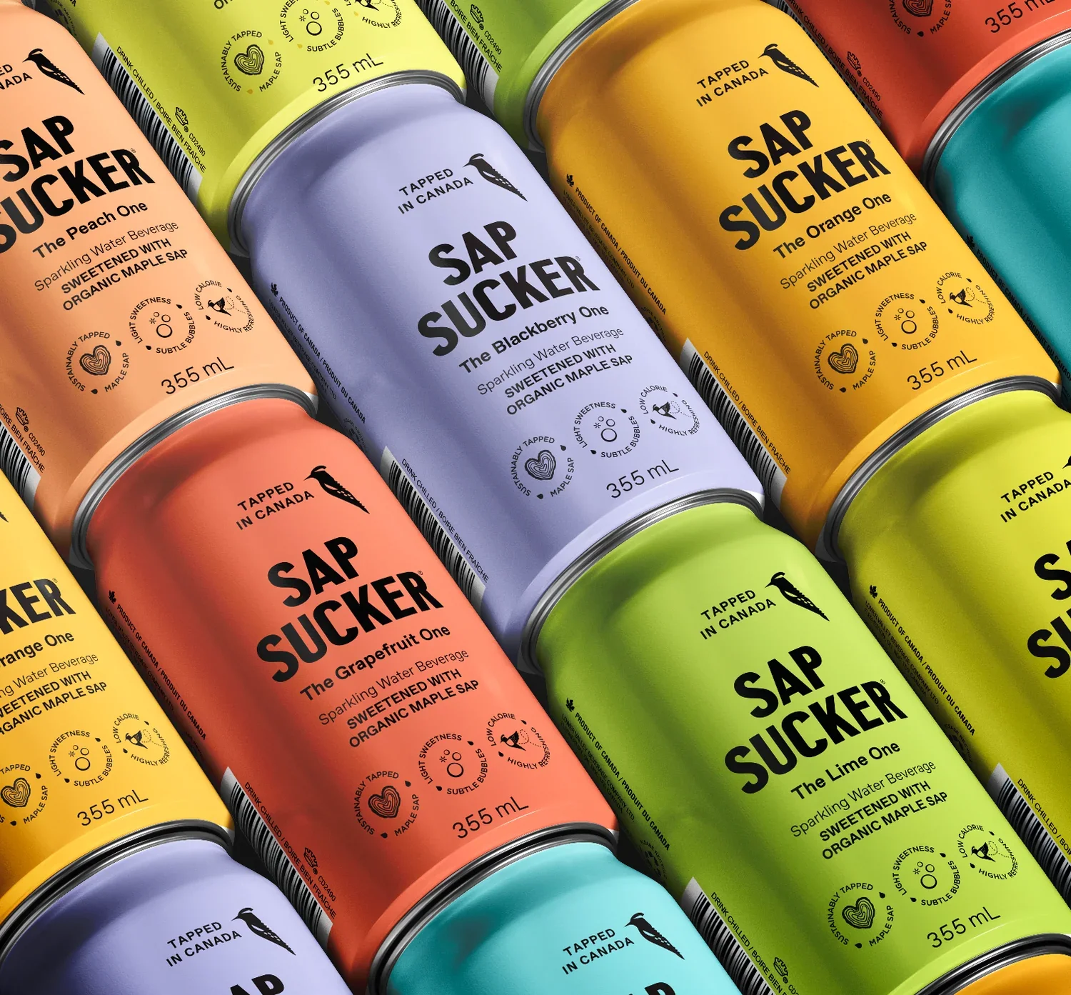 Colorful cans of Sap Sucker sparkling water drinks in various flavors including Blackberry, Orange, Grapefruit, Lime, and Peach, arranged in a pattern.