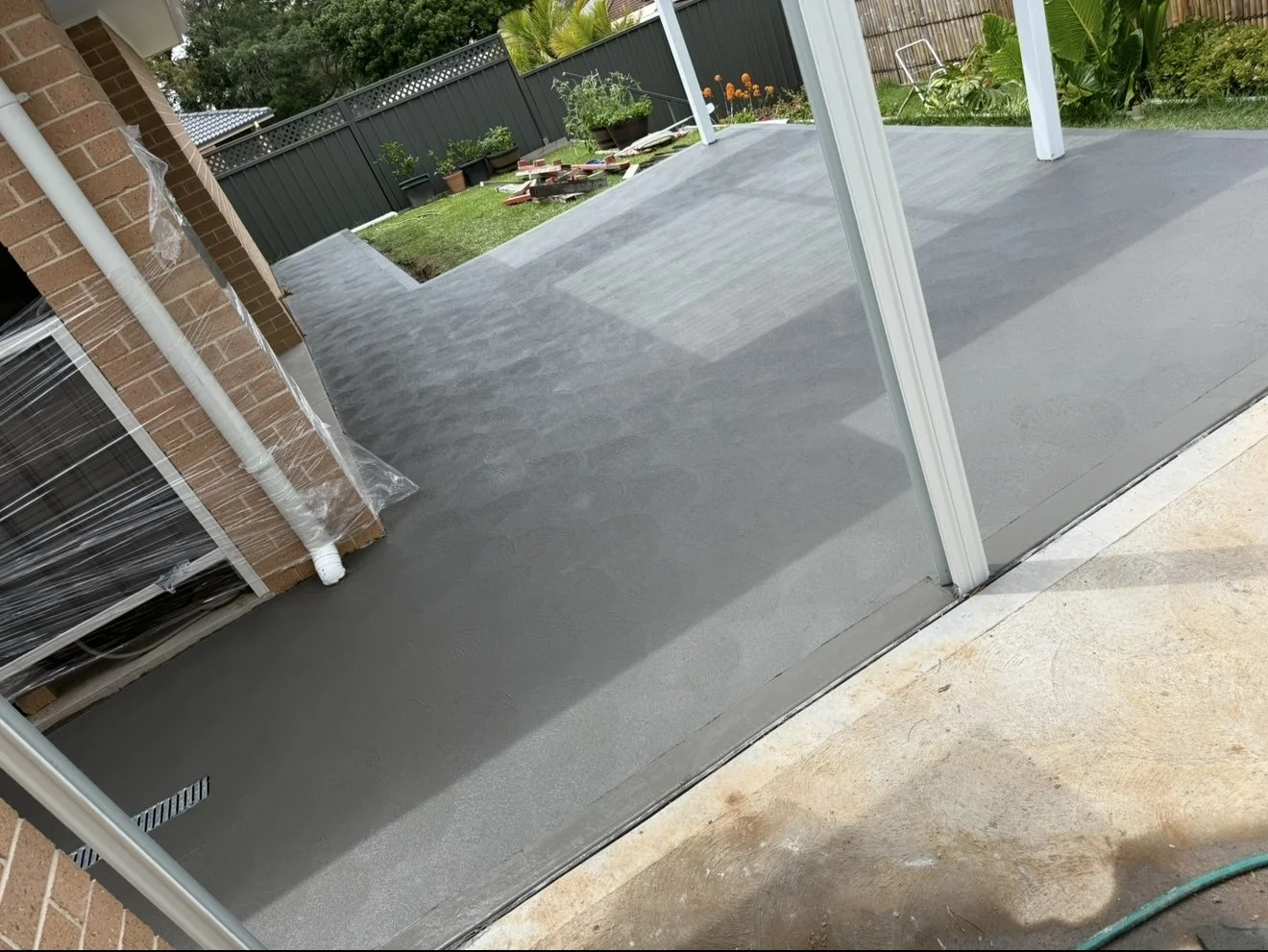Slate grey concrete sidepaths including drain installation in Ambarvale 