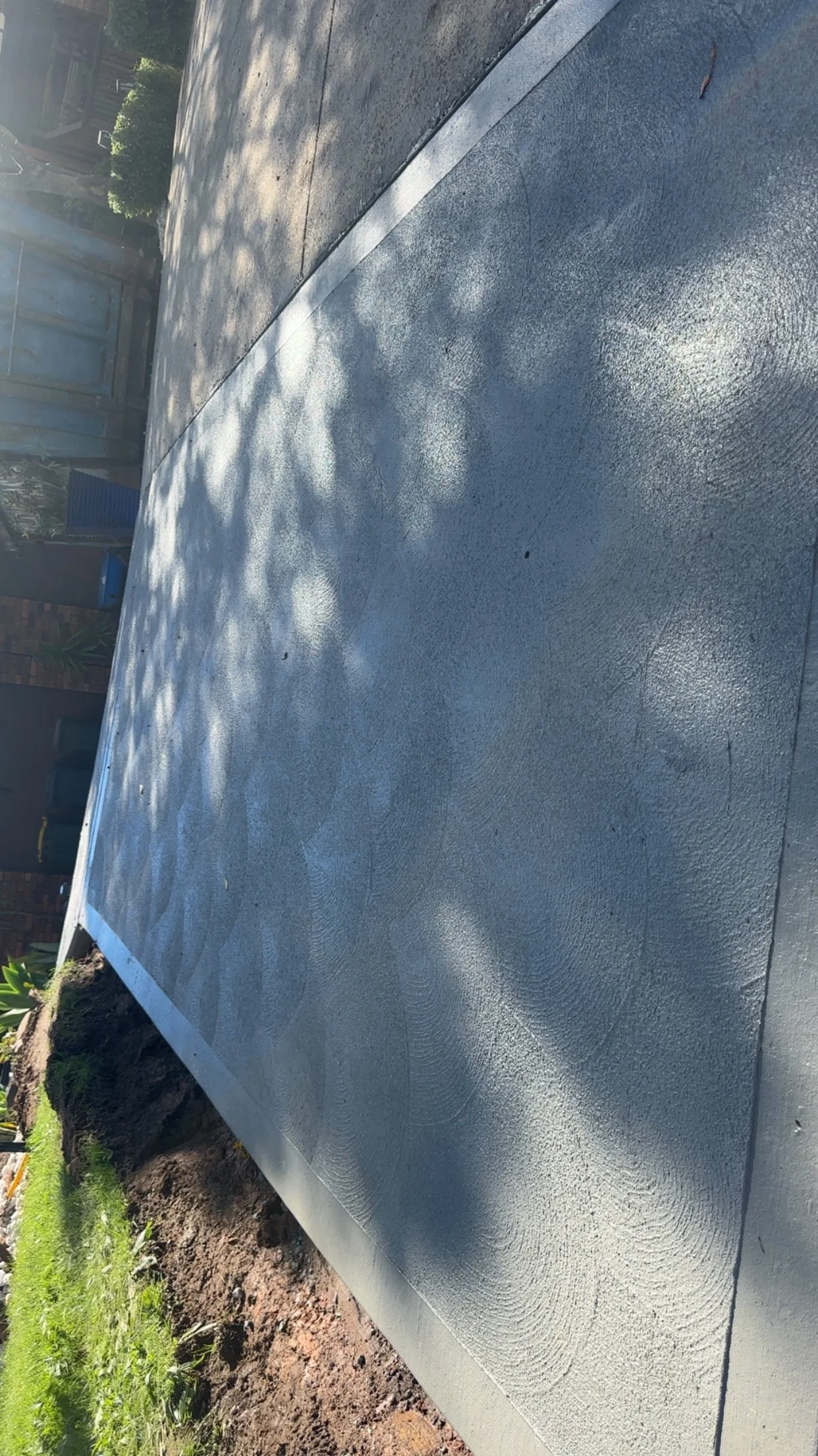 Freshly poured concrete sidewalk with a cove finish