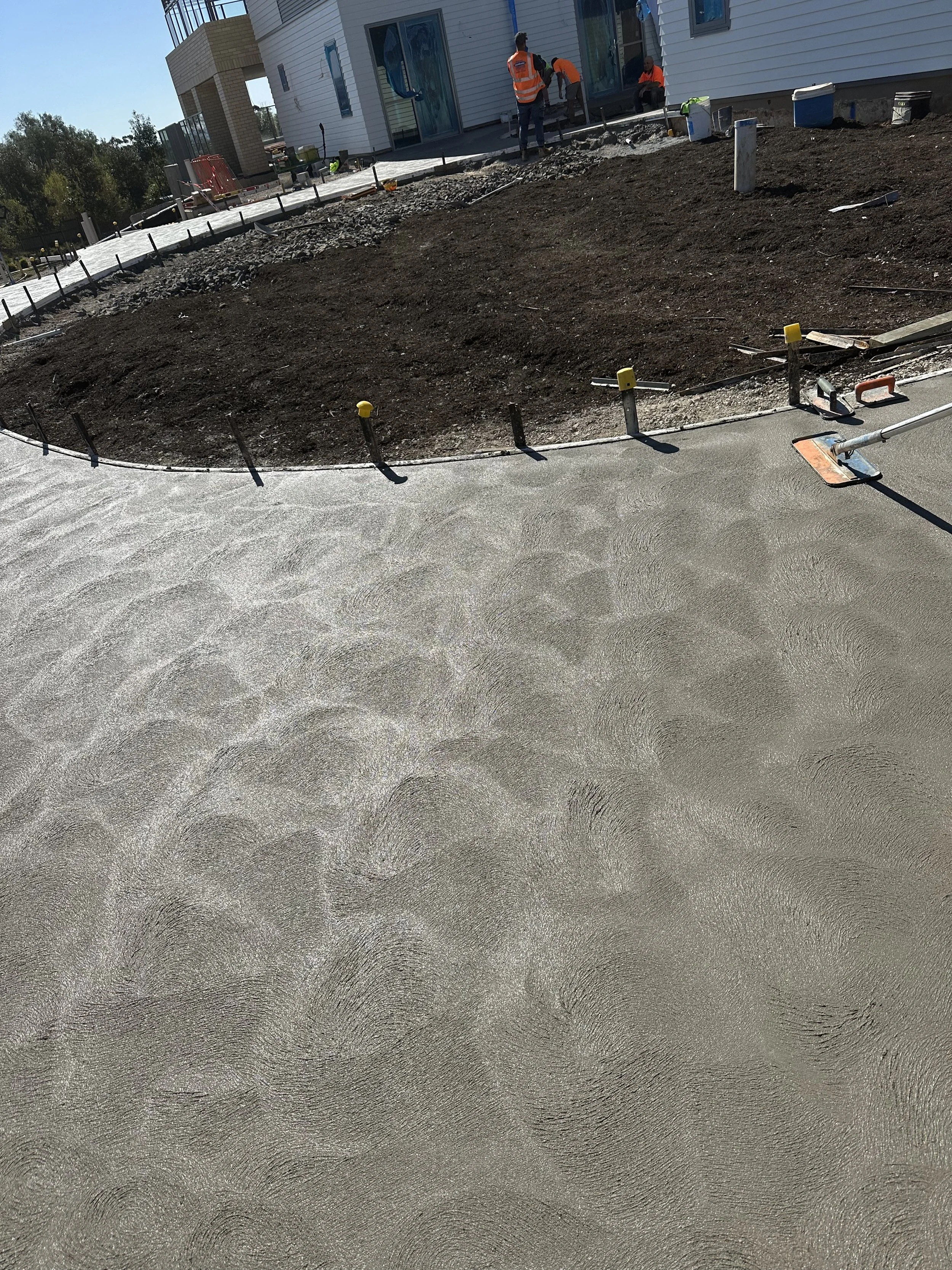 Construction site with fresh concrete driveway