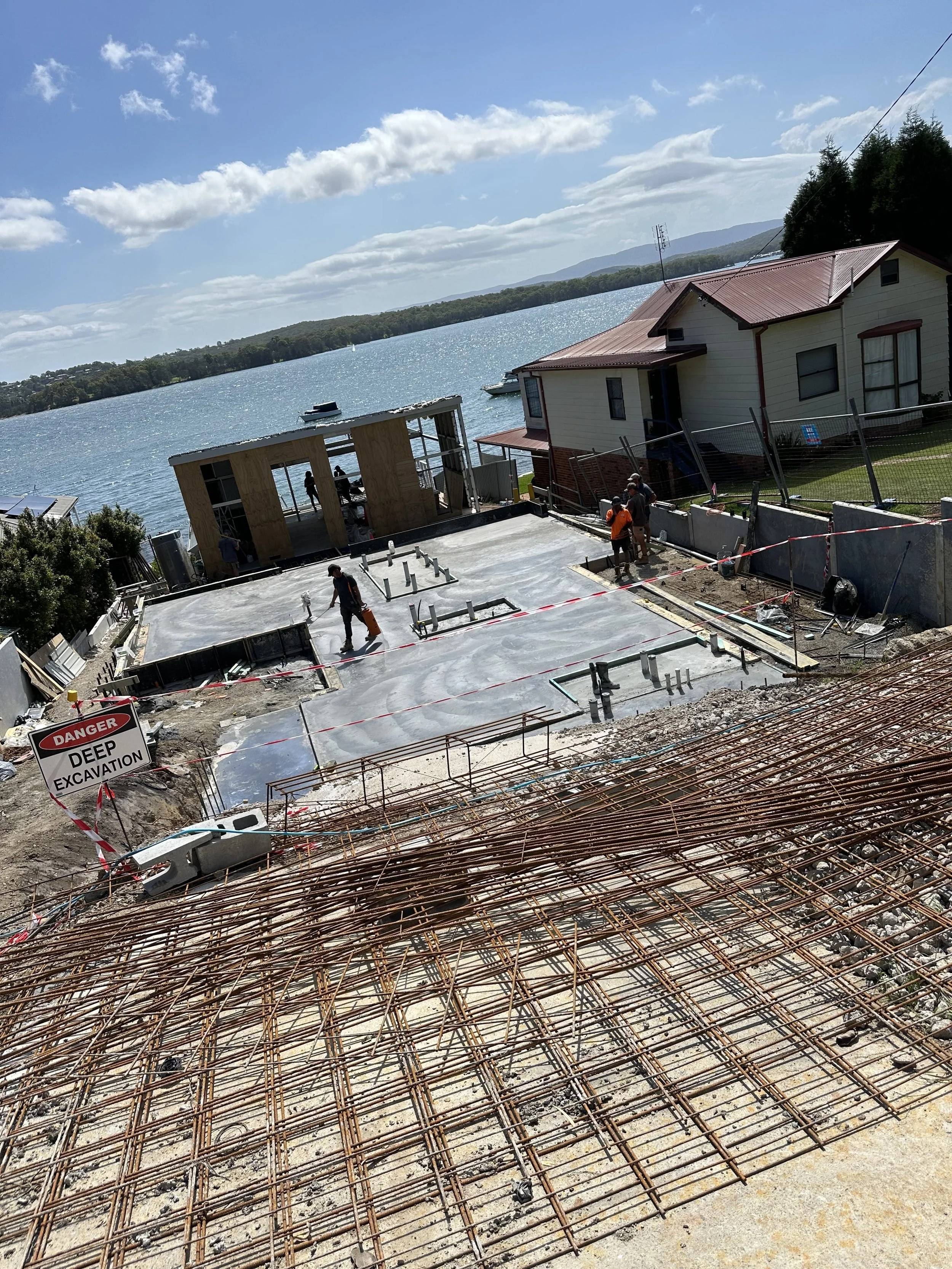 Construction workers work on a concrete foundation 