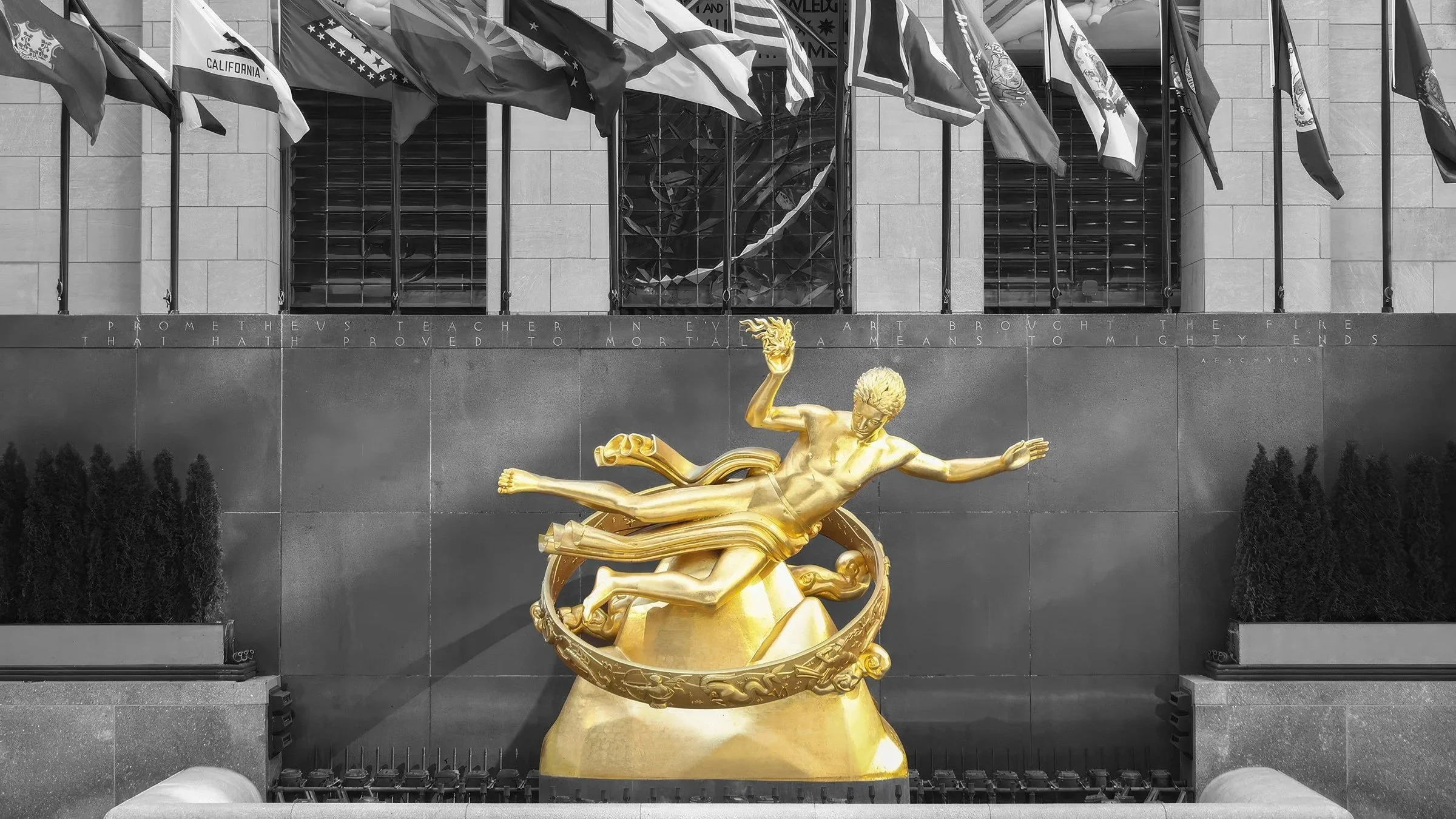 Golden Prometheus statue at Rockefeller Center in New York City, near One Rock Dental’s office. The image is black and white except the Golden Prometheus statue.