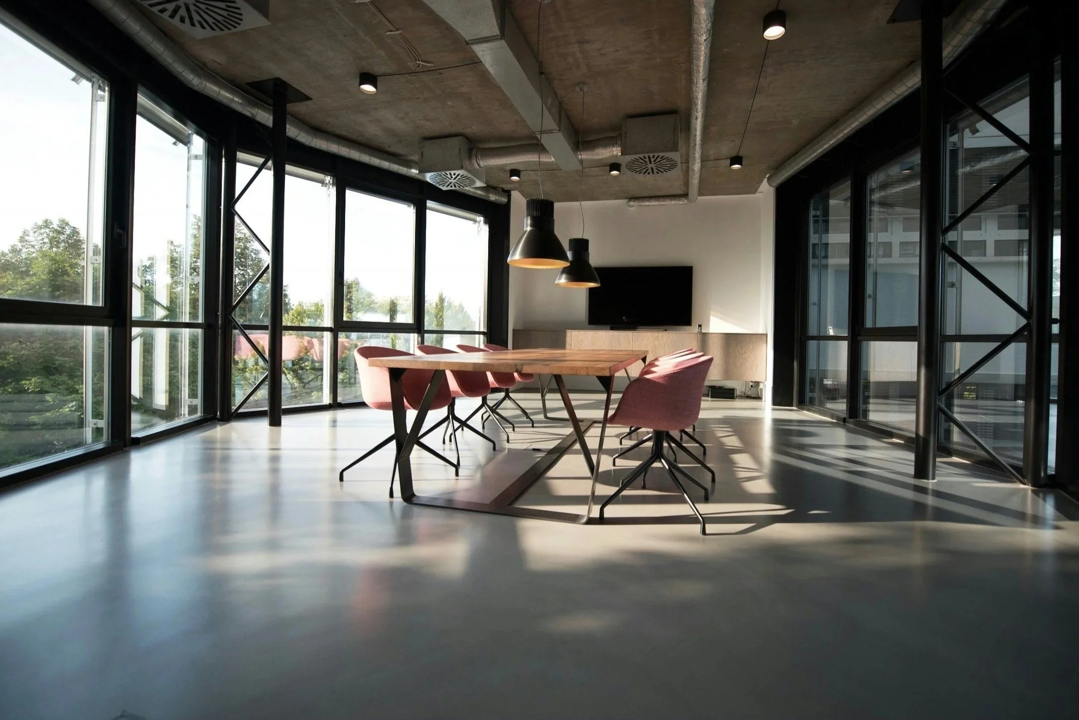 Modern conference room with meeting table and chairs, representing executive consultation and strategic support.