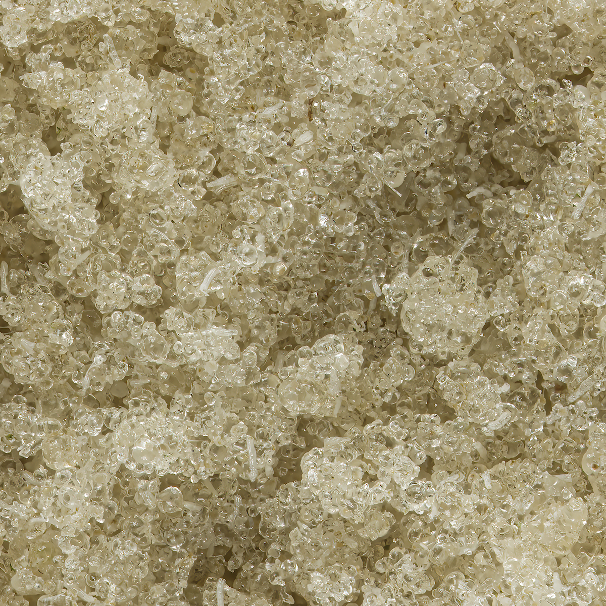 Close-up of tiny, clear plastic or glass beads or pellets.