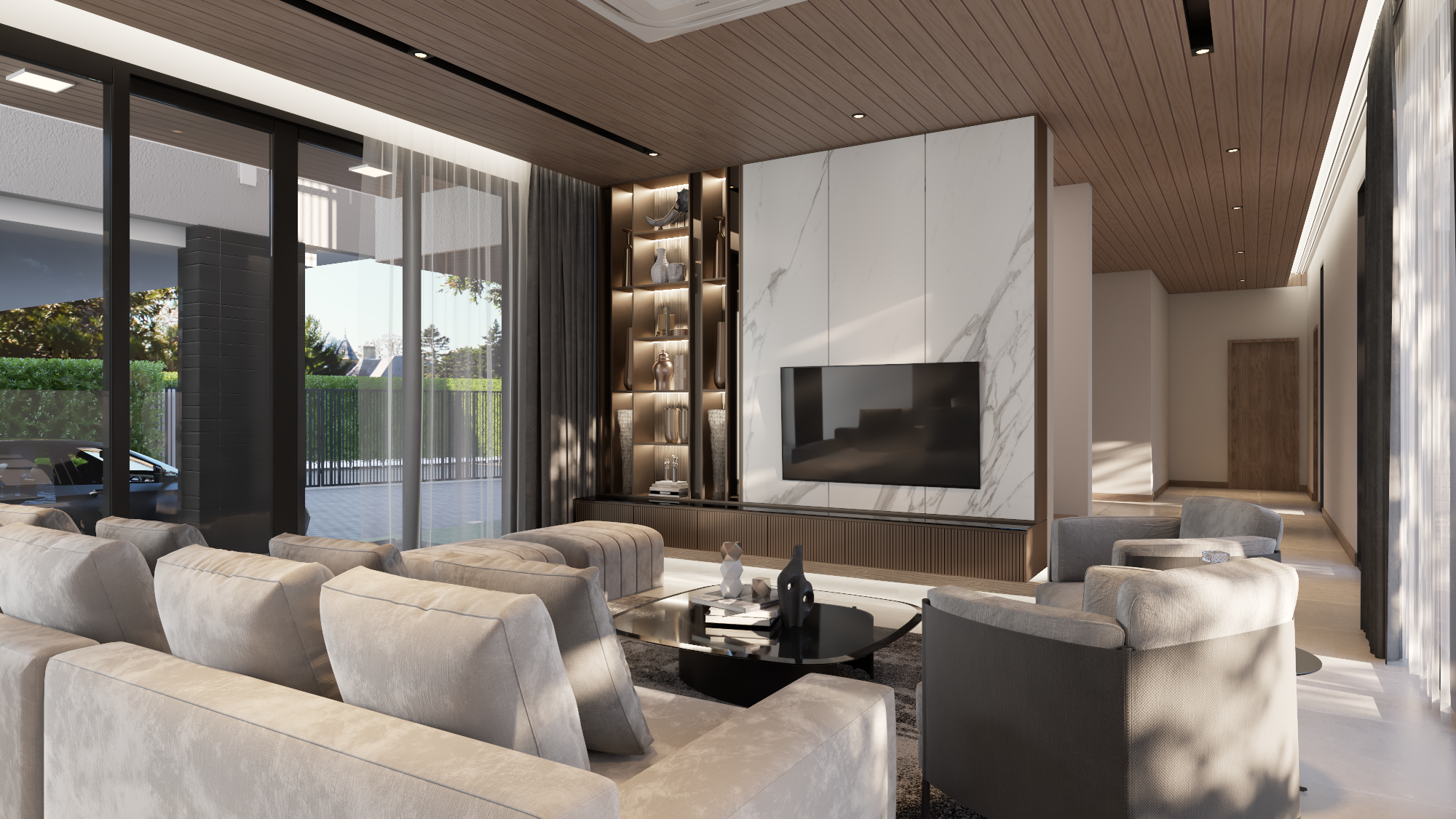 Modern living room with large beige sofa, armchairs, a black coffee table with decorative objects, a flat-screen TV mounted on a marble wall, built-in shelves with decorative items, floor-to-ceiling windows with curtains, and a wooden ceiling with recessed lighting.