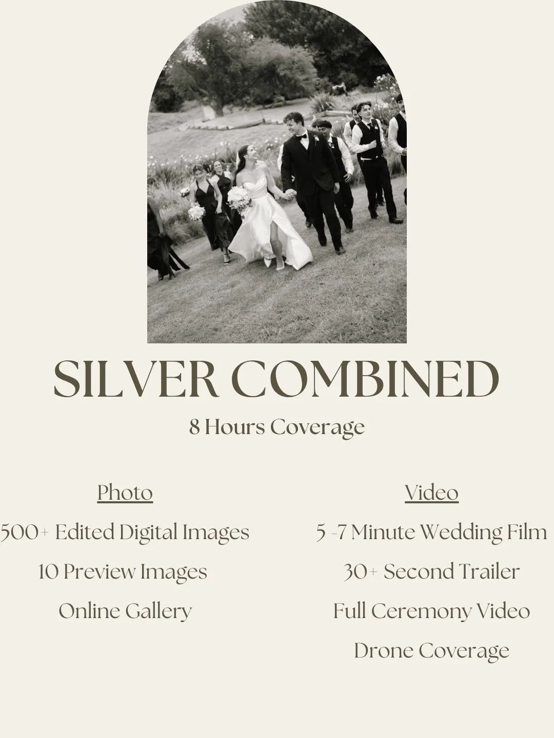 A black and white wedding photo of a bride and groom walking hand in hand with wedding party in a garden setting.