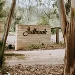 Wooden sign with 'Andover' written on it, situated in a forested area