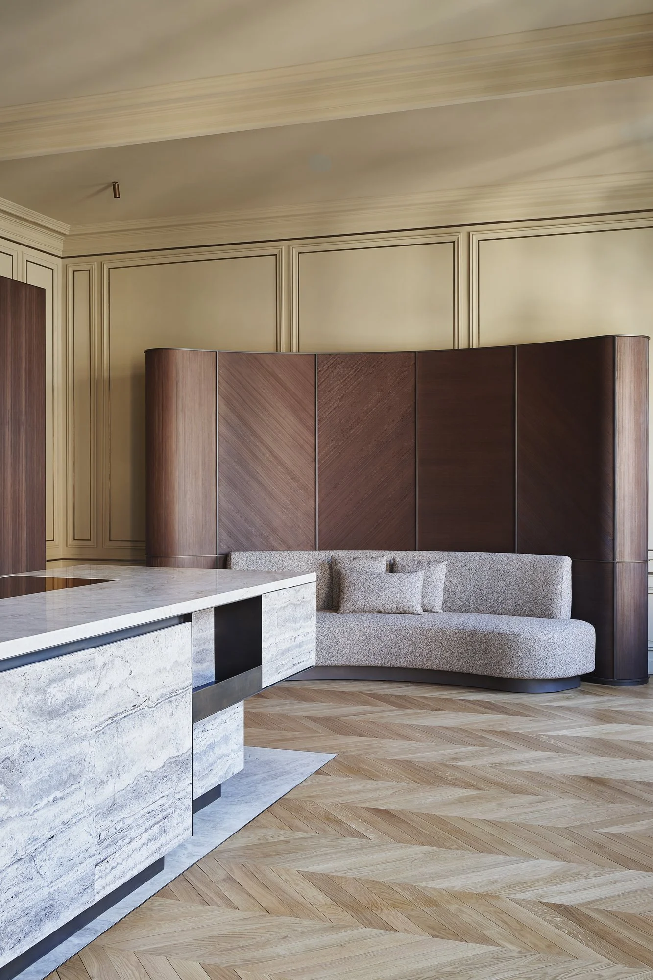 agencement d'une cuisine en travertin et laiton patiné, banquette sur mesure et paravent en épicéa brossé, réalisation par l'ébéniste agenceur Lamellux