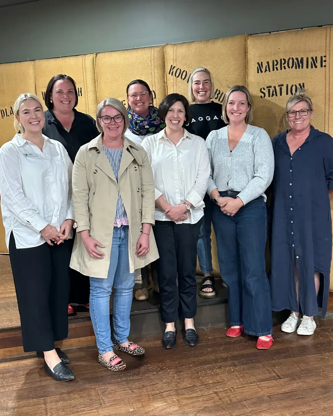 committee members all standing, looking towards the camera smiling