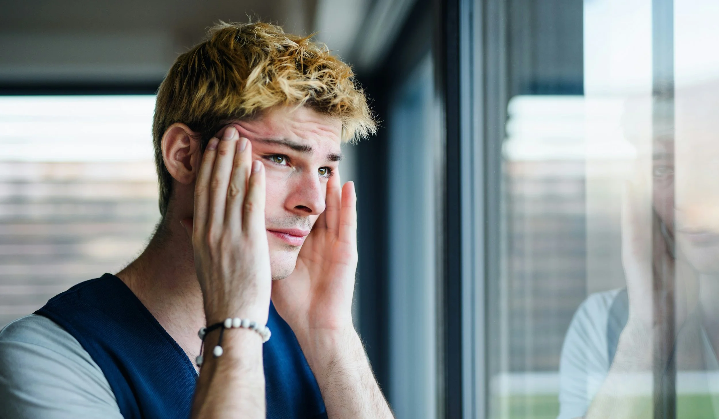 anxious young man rubbing his temples