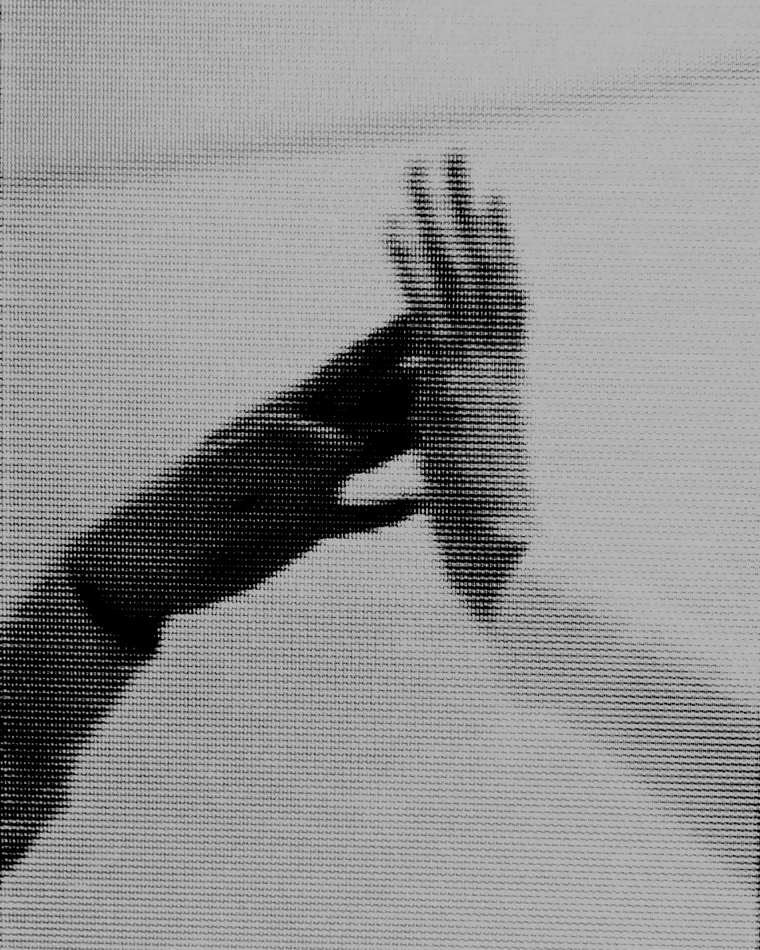 A hand holding a small, detailed model airplane against a plain background.