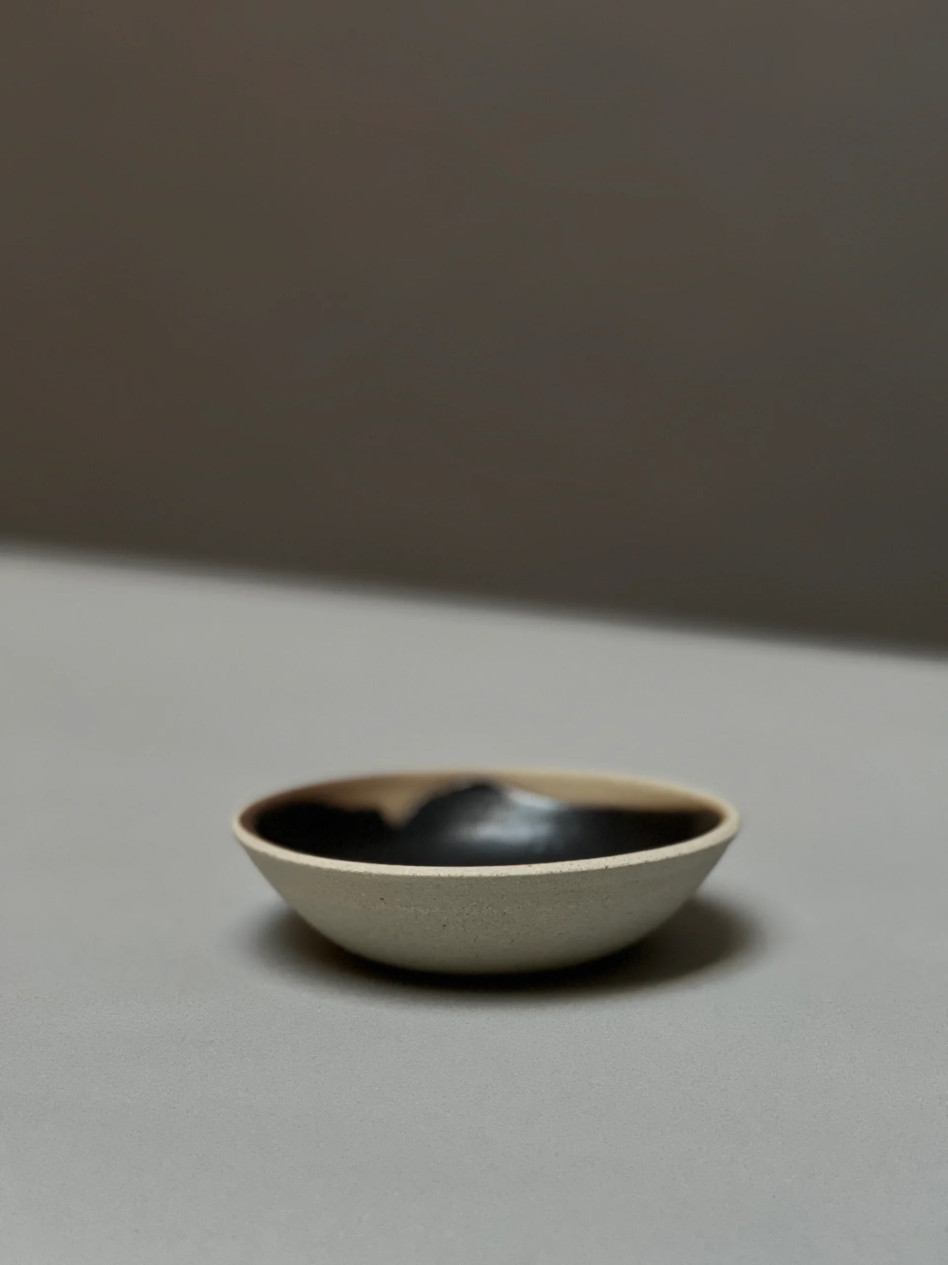 Black clay incense holder side view