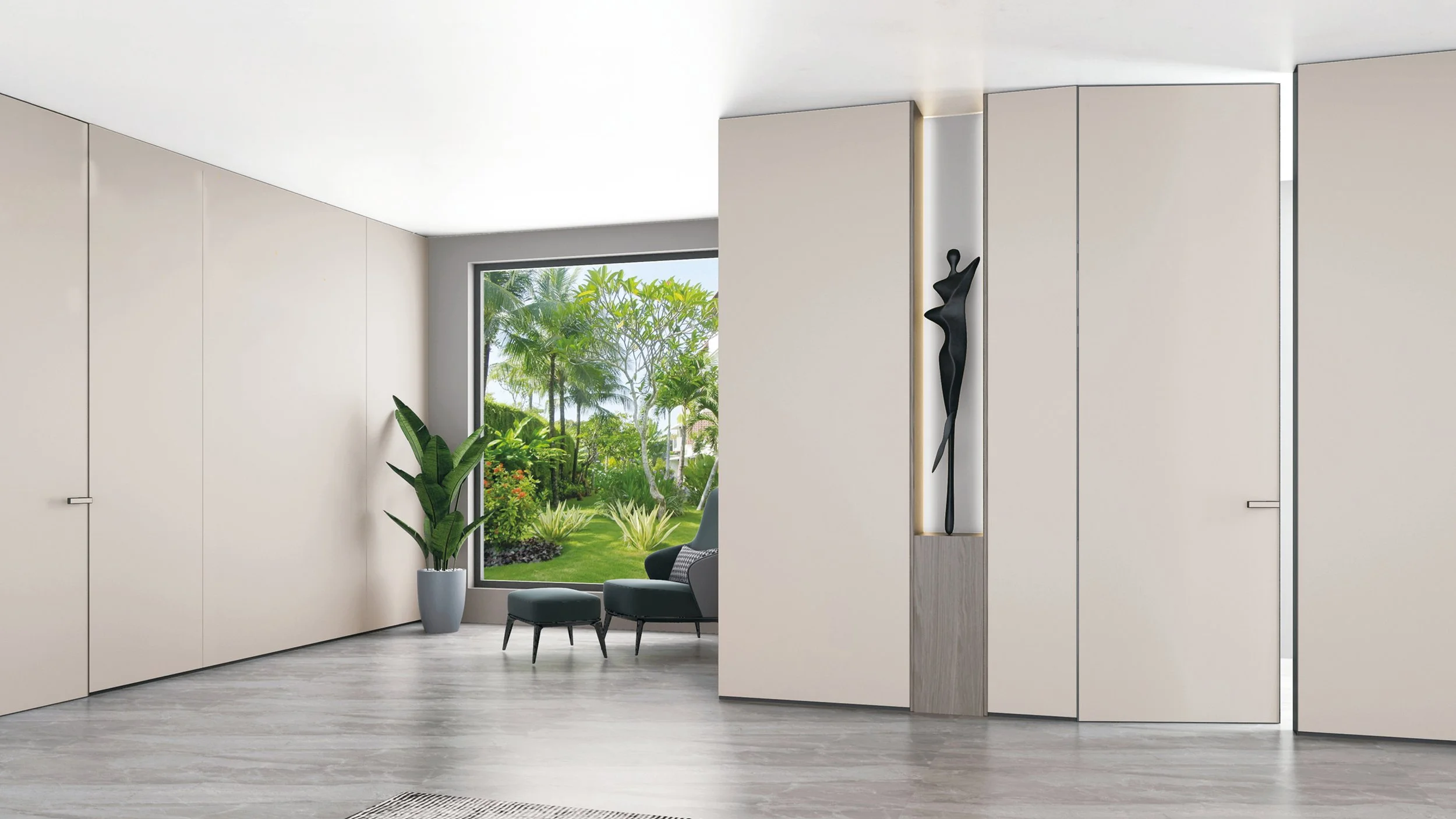 Modern living room with large window view of a lush green garden, white walls, light wood flooring, a black abstract wall sculpture, and a gray chair with an ottoman.