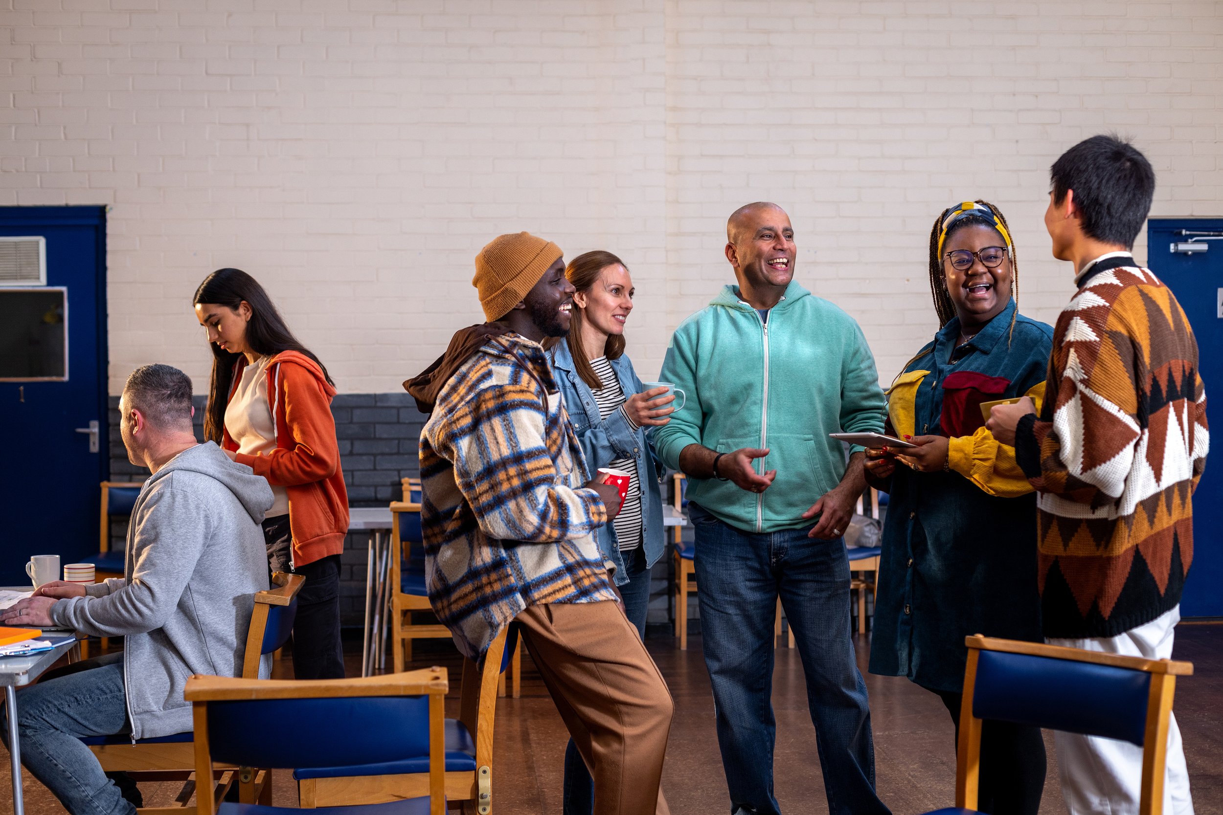 Group of people talking together in a community setting.