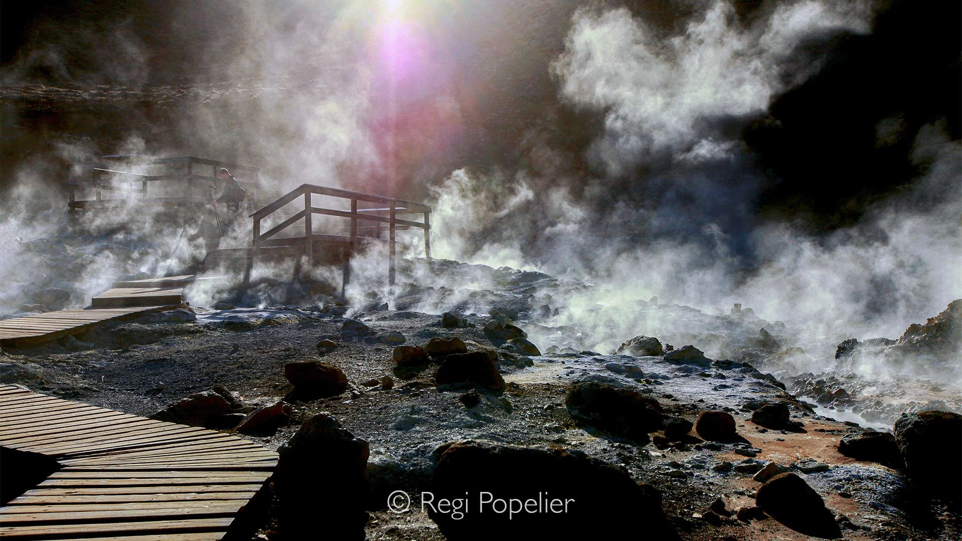 ICEL001 - Friend photographer Vincent while setting-up his equipment, the steam and rising vapor clouds make the image mystical  