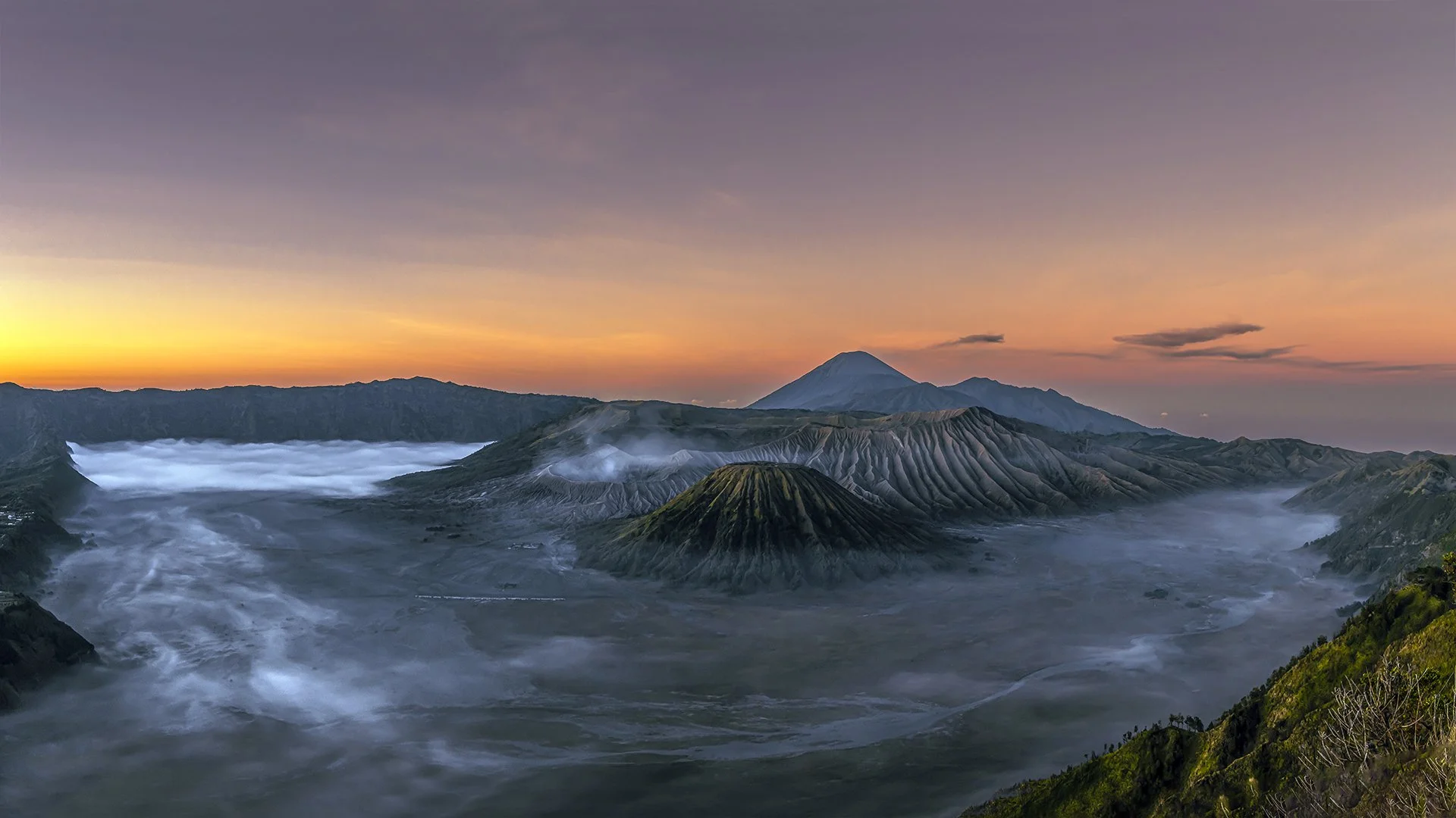 INDO094 - After sunrise, cloud formations still drift and linger over the mountains. Stay at your spot a little longer, as nature often reveals some of its most beautiful moments during this time