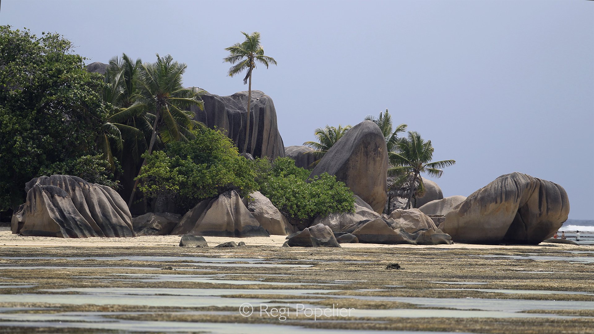 Seychelles003 -  Towering granite sculptures stand silently beside the sea, shaped by centuries of wind, water, and time.