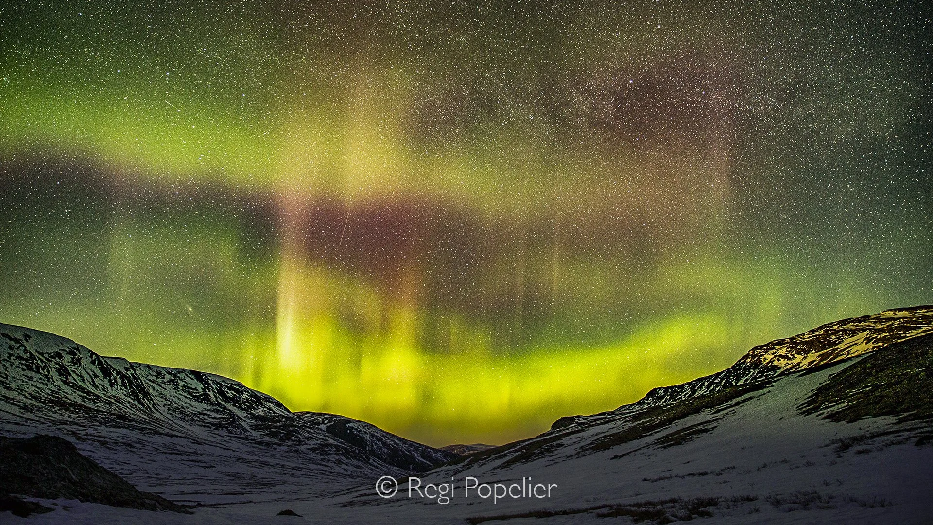 NORWAY062 - Countless stars fill the heavens as the Aurora Borealis weaves ribbons of light across the night, transforming the Norwegian wilderness into a dreamlike landscape of silence and wonder.