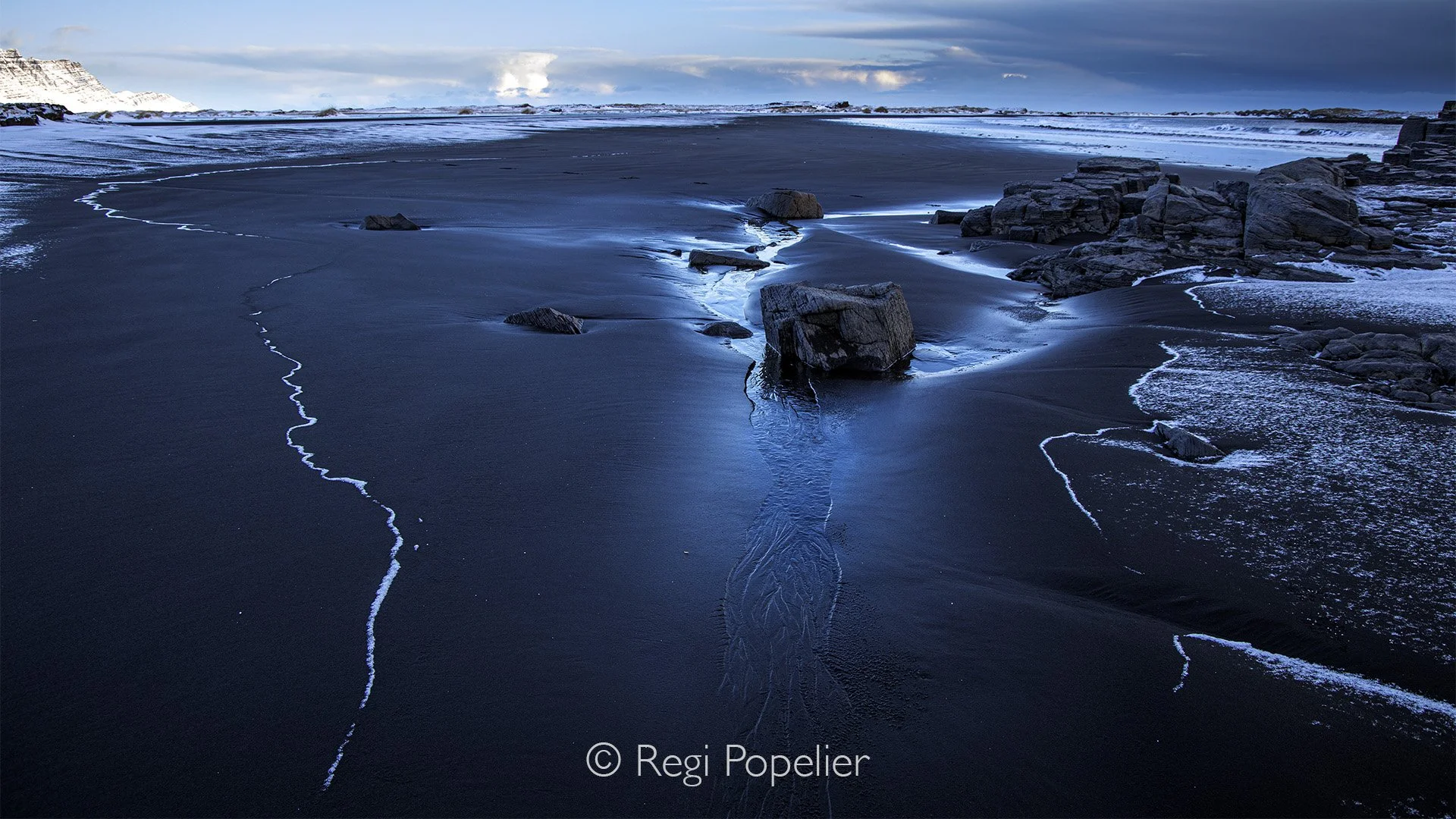ICEL004 - Sitting in a chariot on the way to the west coast to photograph the puffins a wheel broke of the chariot , this gave me time to photograph the black sand landscape 