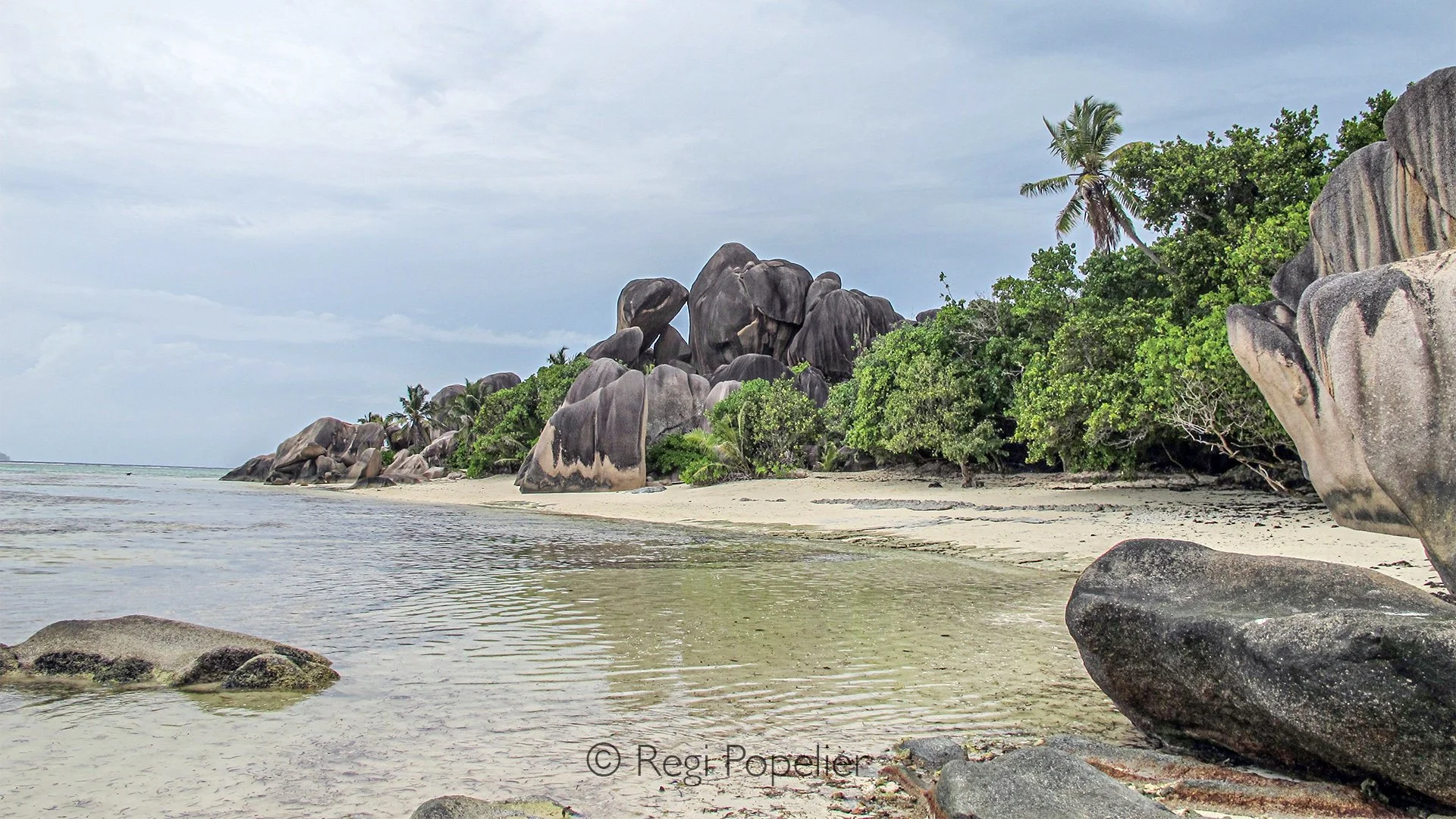 Seychelles004 -  The wild coastline of the Seychelles is a harmony of sculpted rock, white sand, and the endless sea.