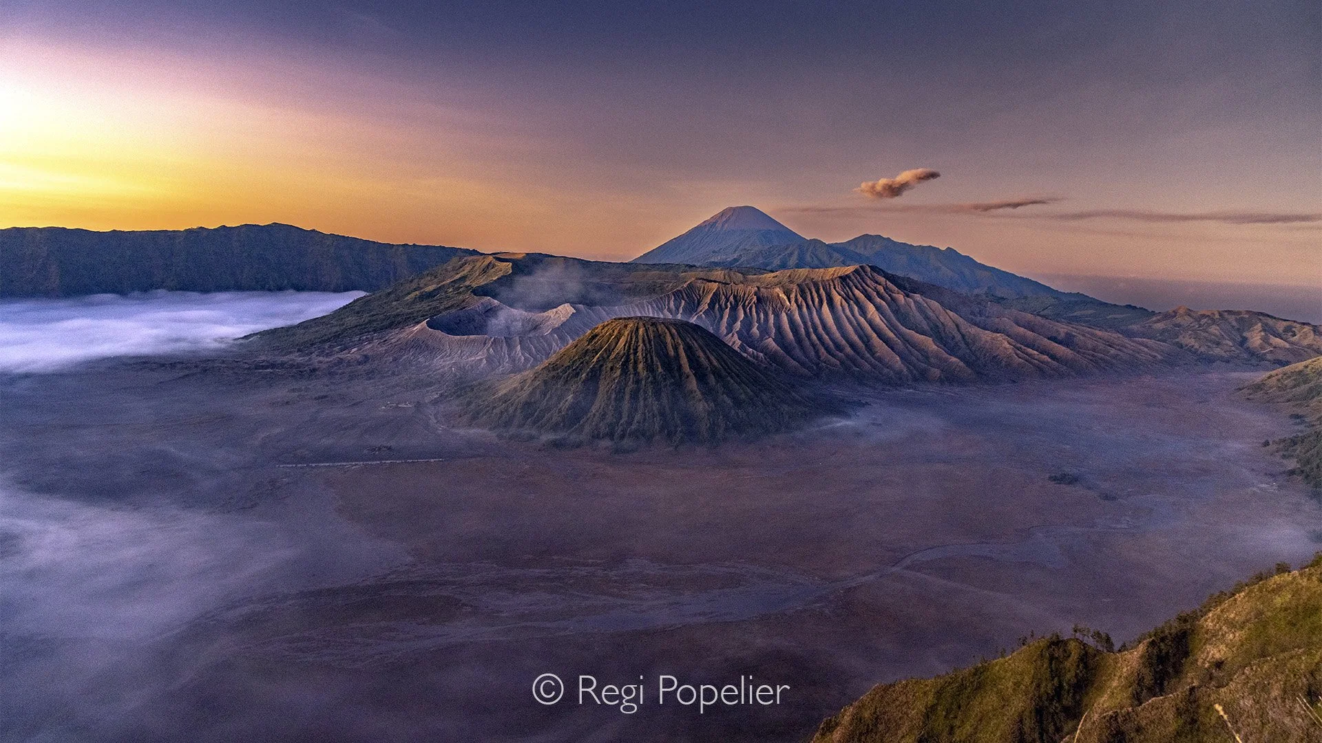 INDO092 - At sunrise on Mount Bromo, finding a good spot to capture strong photographs can be quite challenging, as the best viewpoints quickly fill with eager visitors and photographers.