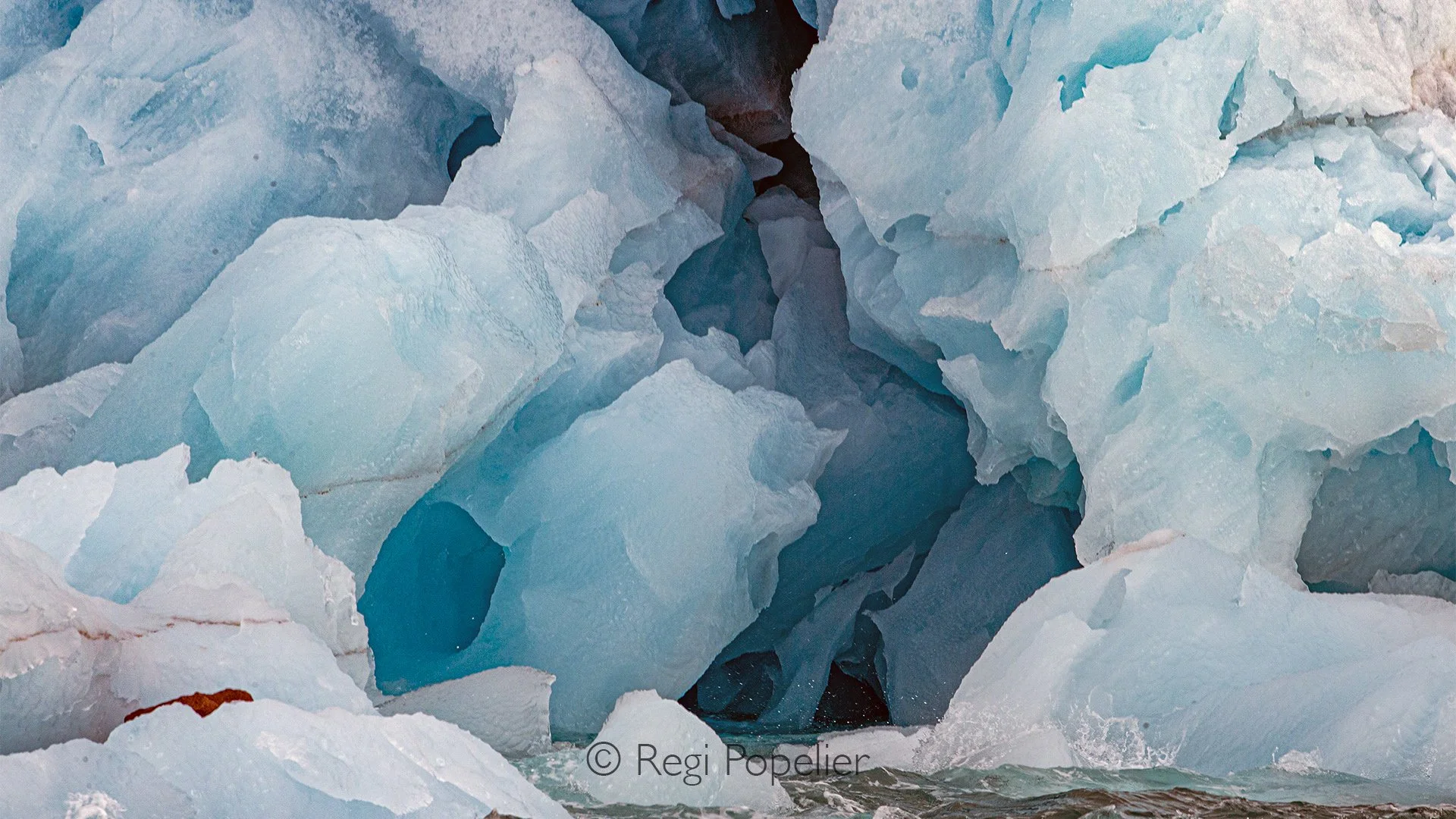 NPOLE005  - Intricate patterns and deep blue tones reveal the beauty hidden within the glacier.