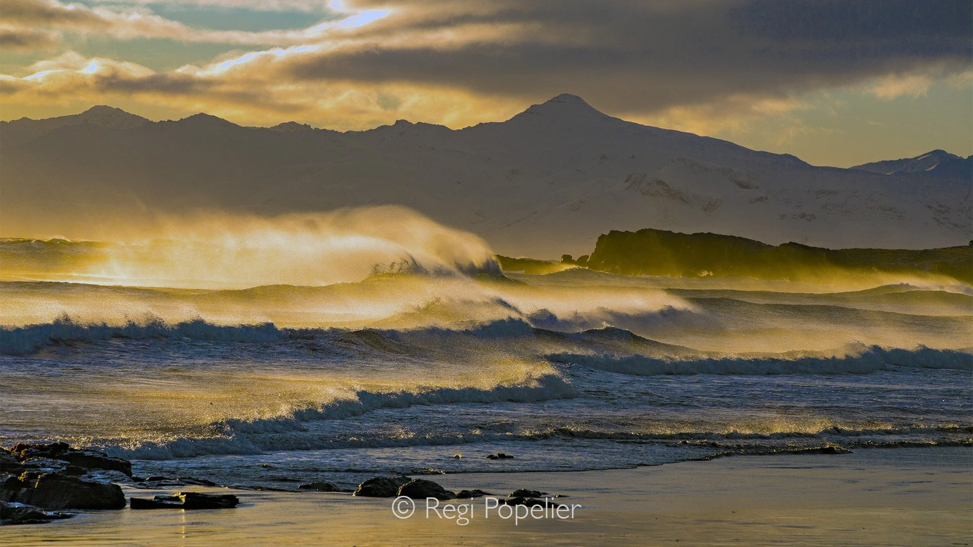 ICEL060 - The last morning of my trip, sunrise on the wild west coast of Iceland.
The wind swept relentlessly across the shoreline, tugging at my jacket and rattling the tripod, while the rising sun spilled a golden glow over the restless sea. Waves,