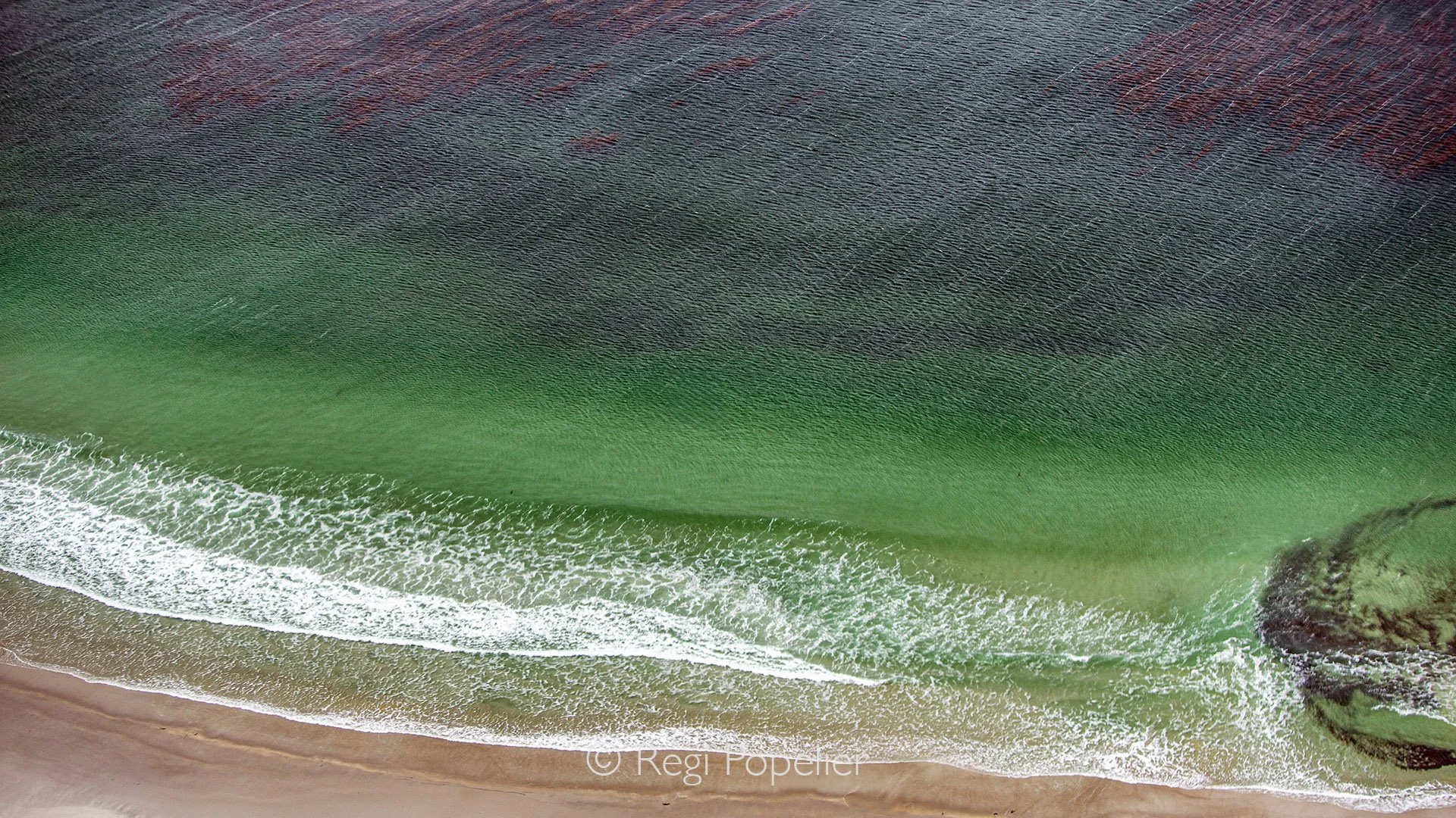 FAL020 - Bird’s-eye perspective on the sparkling, multicolored waters around the Falklands.