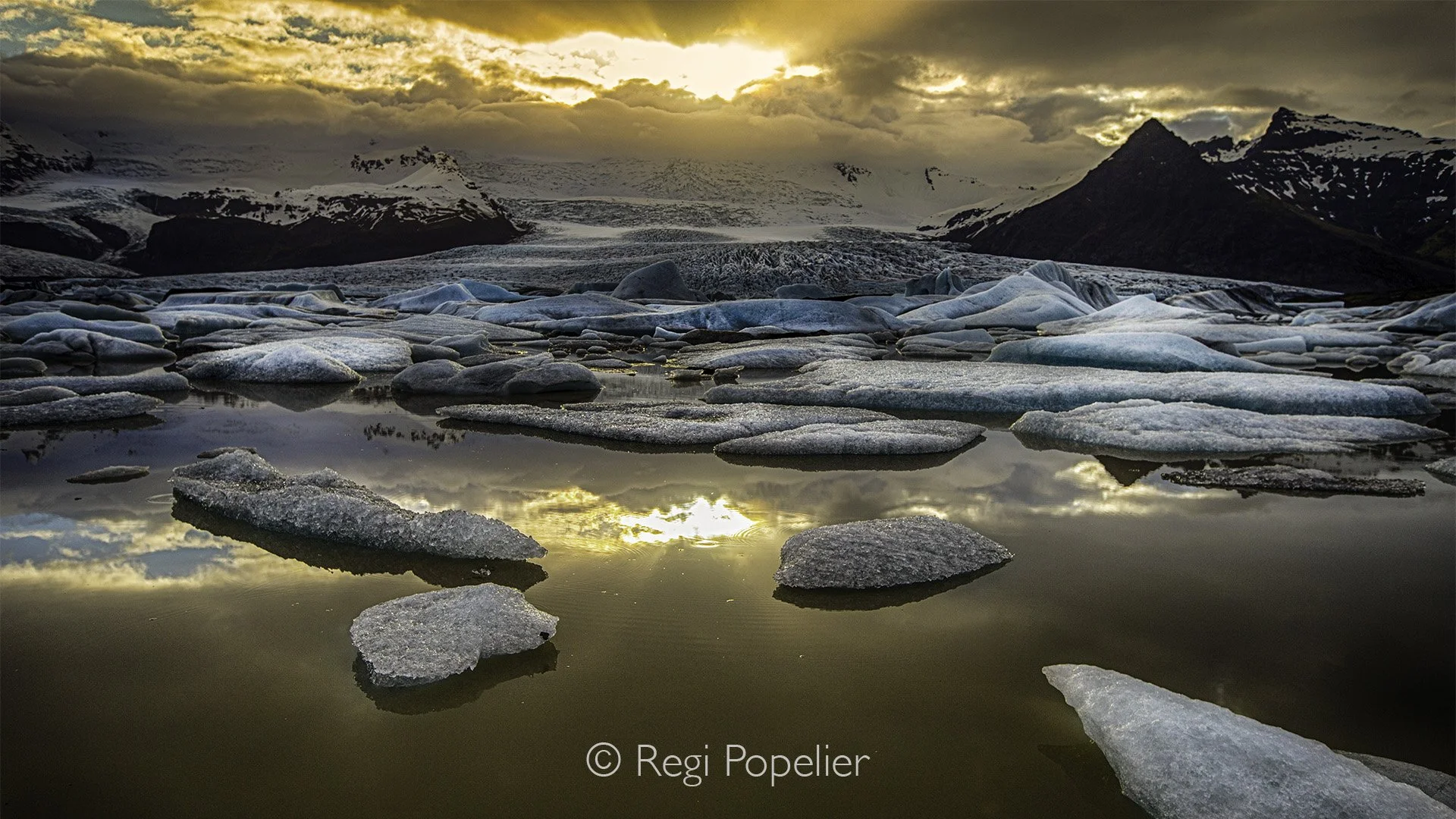 ICEL019 -  Icebergs get carved by the waves for a long and take on a transparent shape like that of crystals or diamonds. located near the Jökulsárlón glacier lagoon. photographed at around 10,3 pm. 