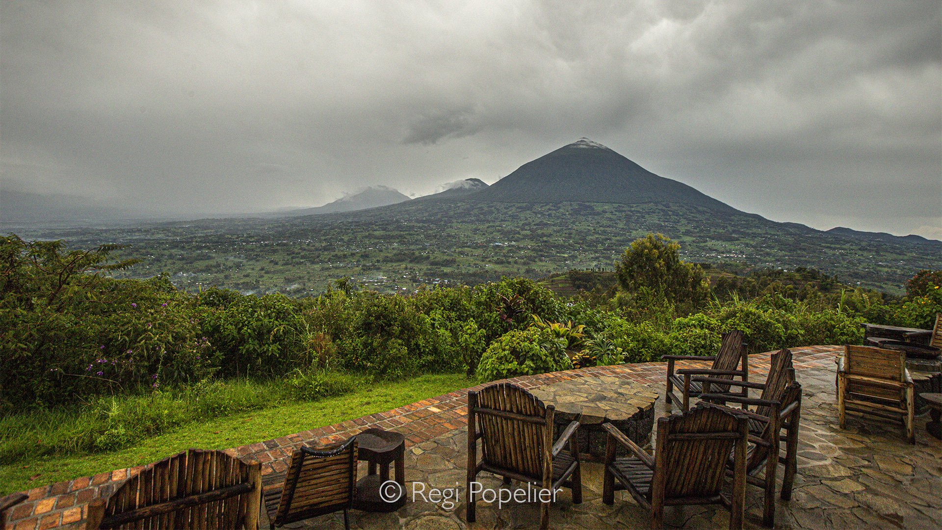 RWANDA034  - From the quiet terrace of my lodge, the Virunga Mountains unfold beneath the first light of dawn. Layers of mist drift through the valleys while the volcanic peaks slowly emerge, revealing one of Africa's most breathtaking landscapes.