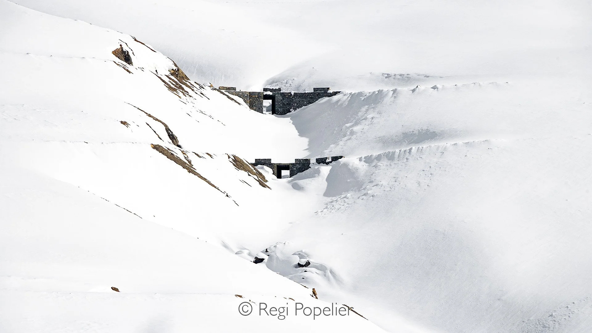 HIMA011 - View on a double bridge not entirely covered by snow while walking to our homestay 
